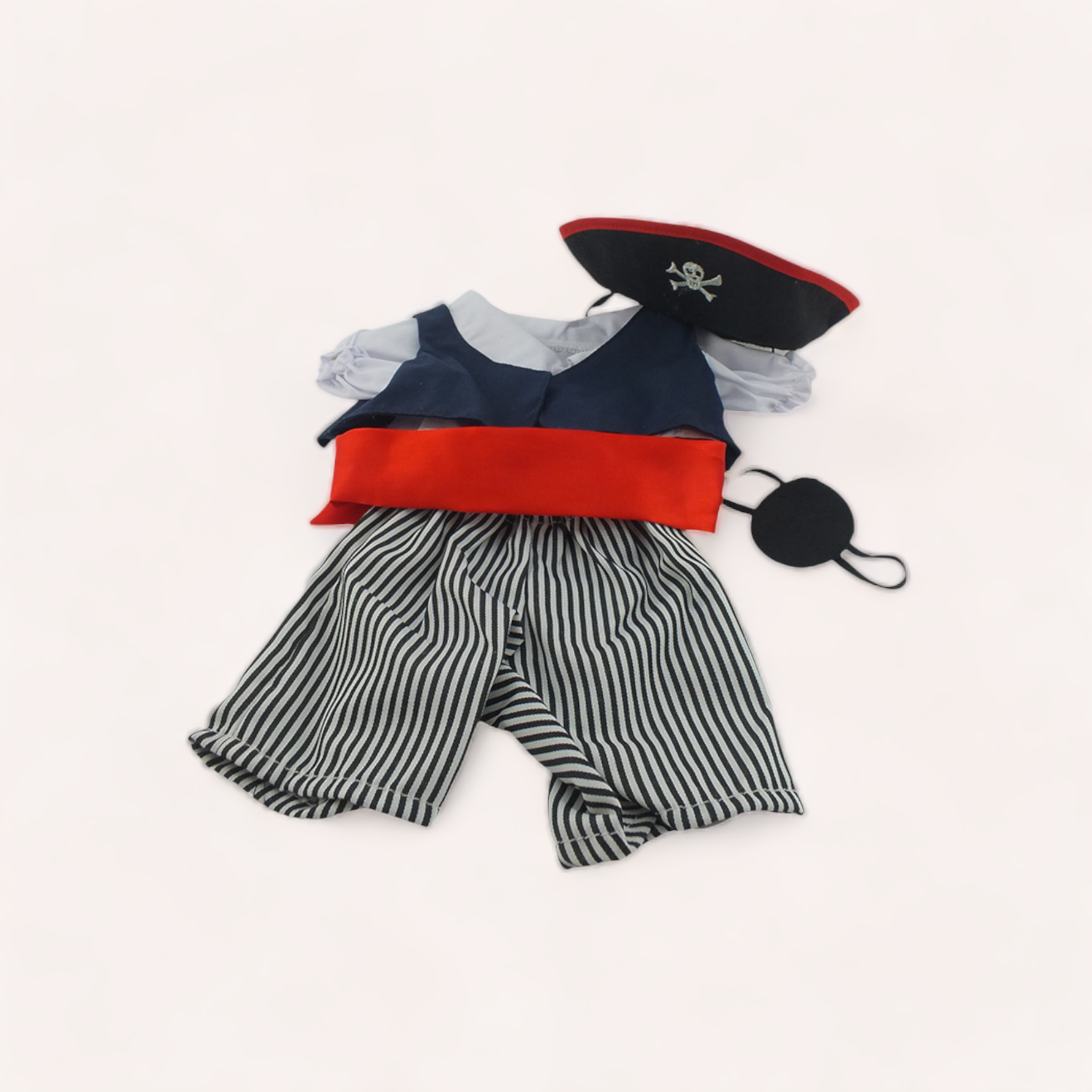 A Pirate Bear Outfit from The Teddy Factory with striped pants, a blue and red vest, white ruffled shirt, and a pirate hat with a skull and crossbones emblem, all laid out on a white.