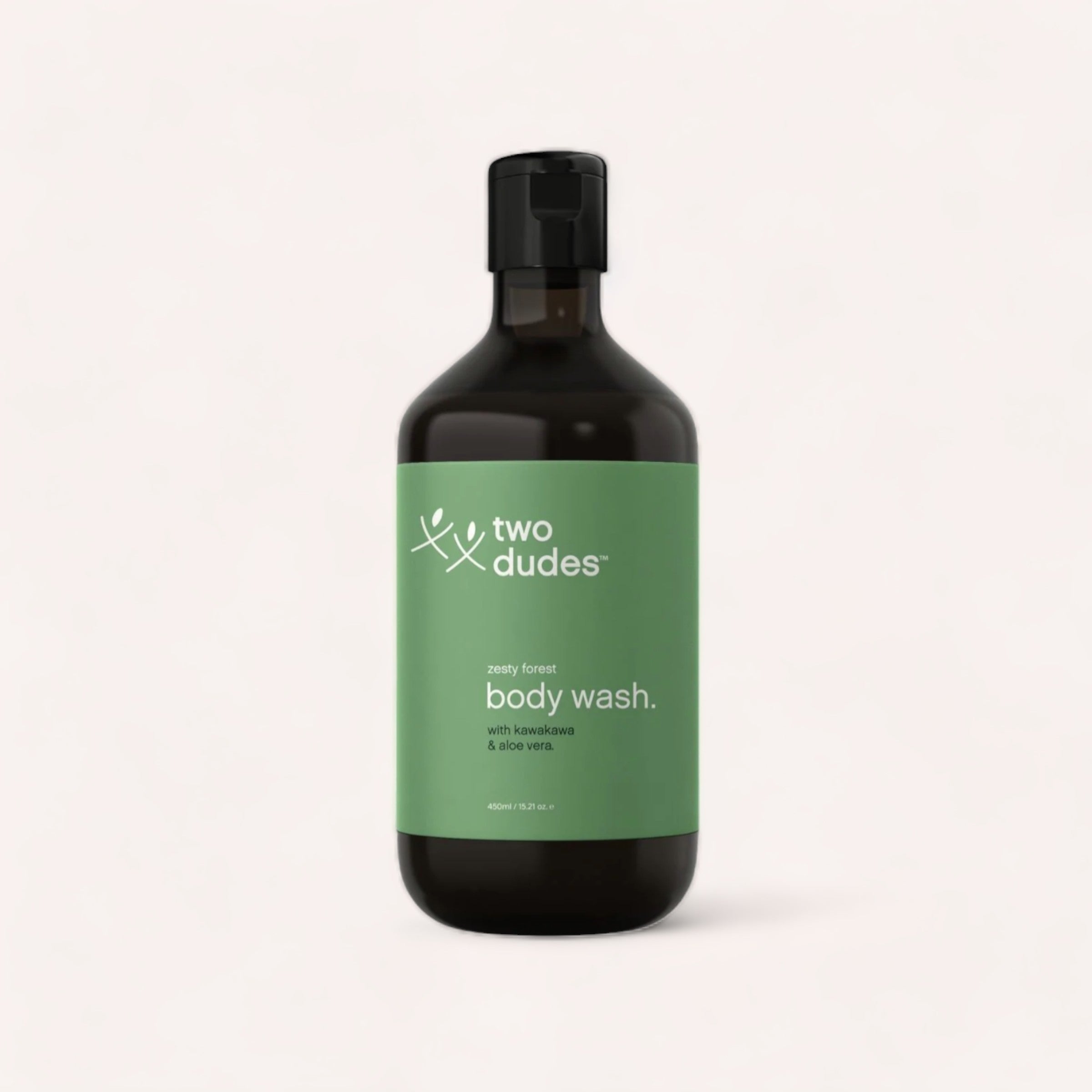A sleek bottle of "Body Wash by Two Dudes" with a minimalist design featuring a green label, advertising a "zesty forest" scent with kawakawa and aloe vera.