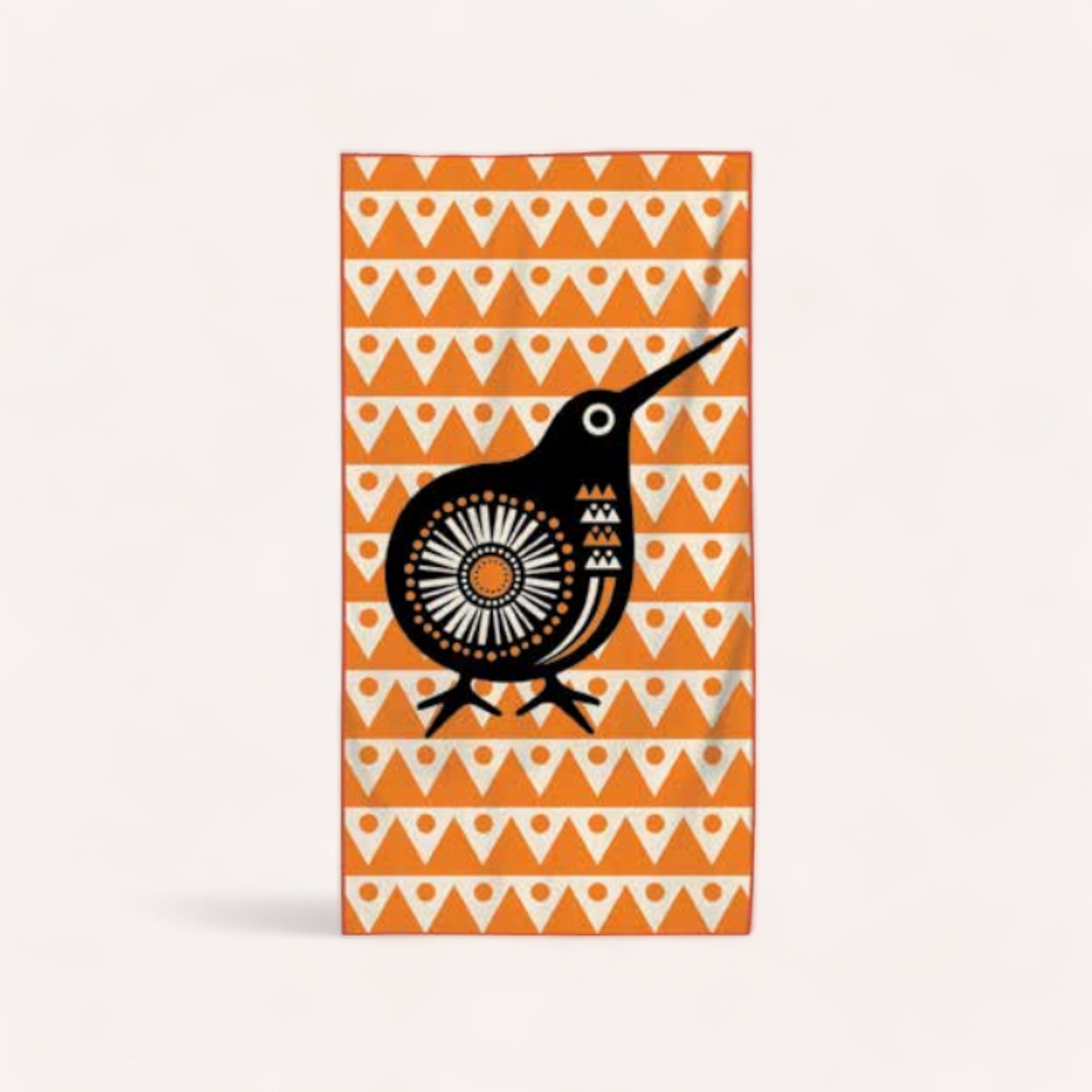 Abstract tribal bird illustration on a patterned orange background, ultra absorbent microfibre Compact Kiwi Beach Towel by Design by Leonard.