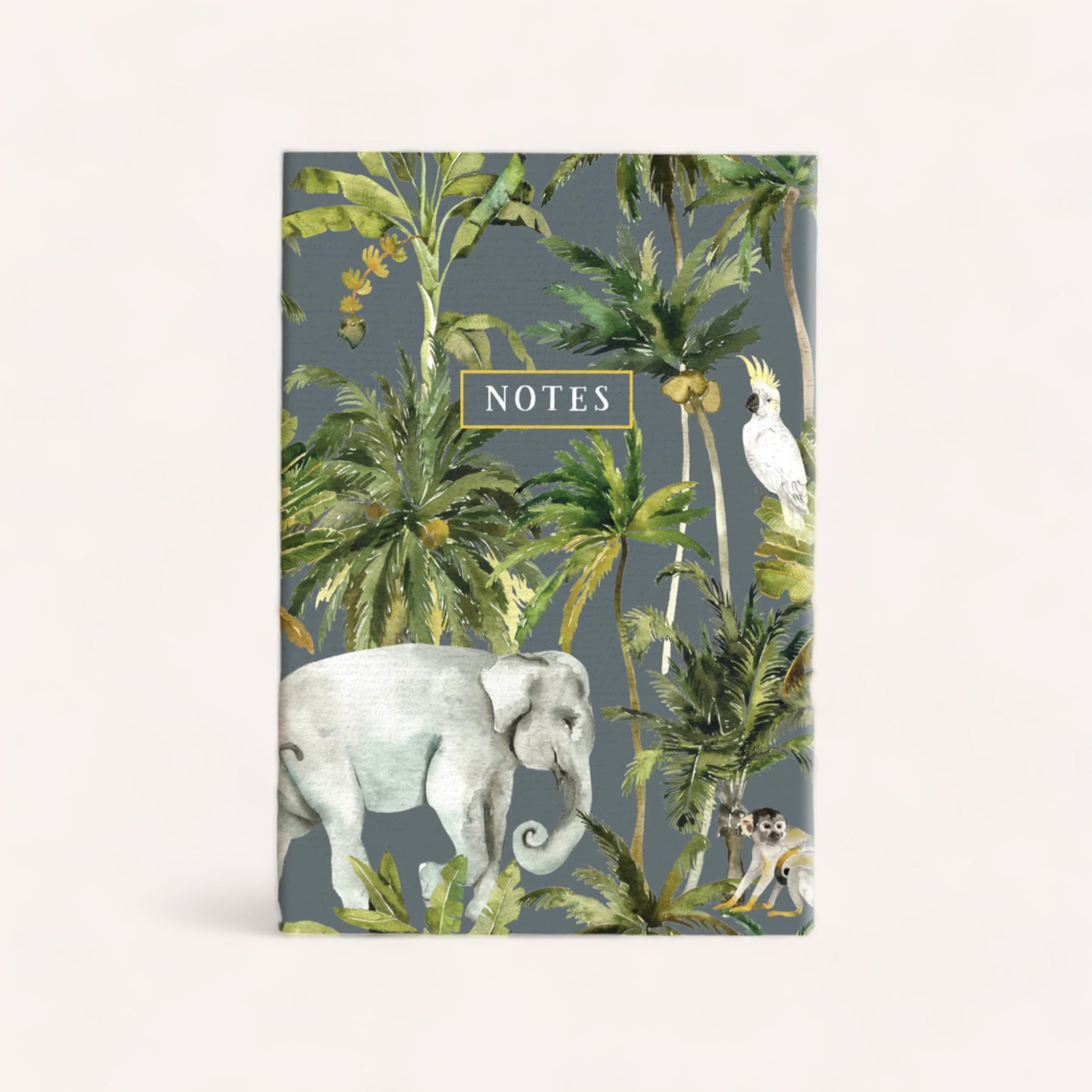An elegant Jungle Notebook with a tropical jungle theme, featuring illustrations of an elephant, parrot, and monkey among lush greenery from Ink Bomb.