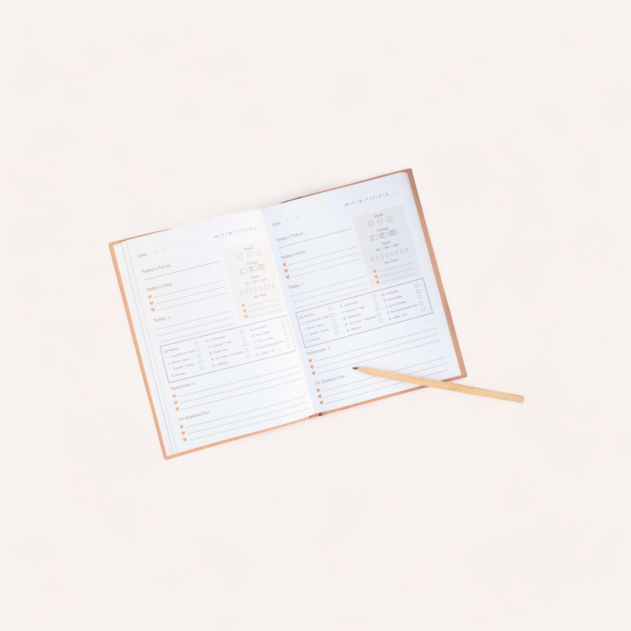 An open Skye self-care journal planner with a to-do list and schedule alongside a pencil, neatly arranged on a plain background.