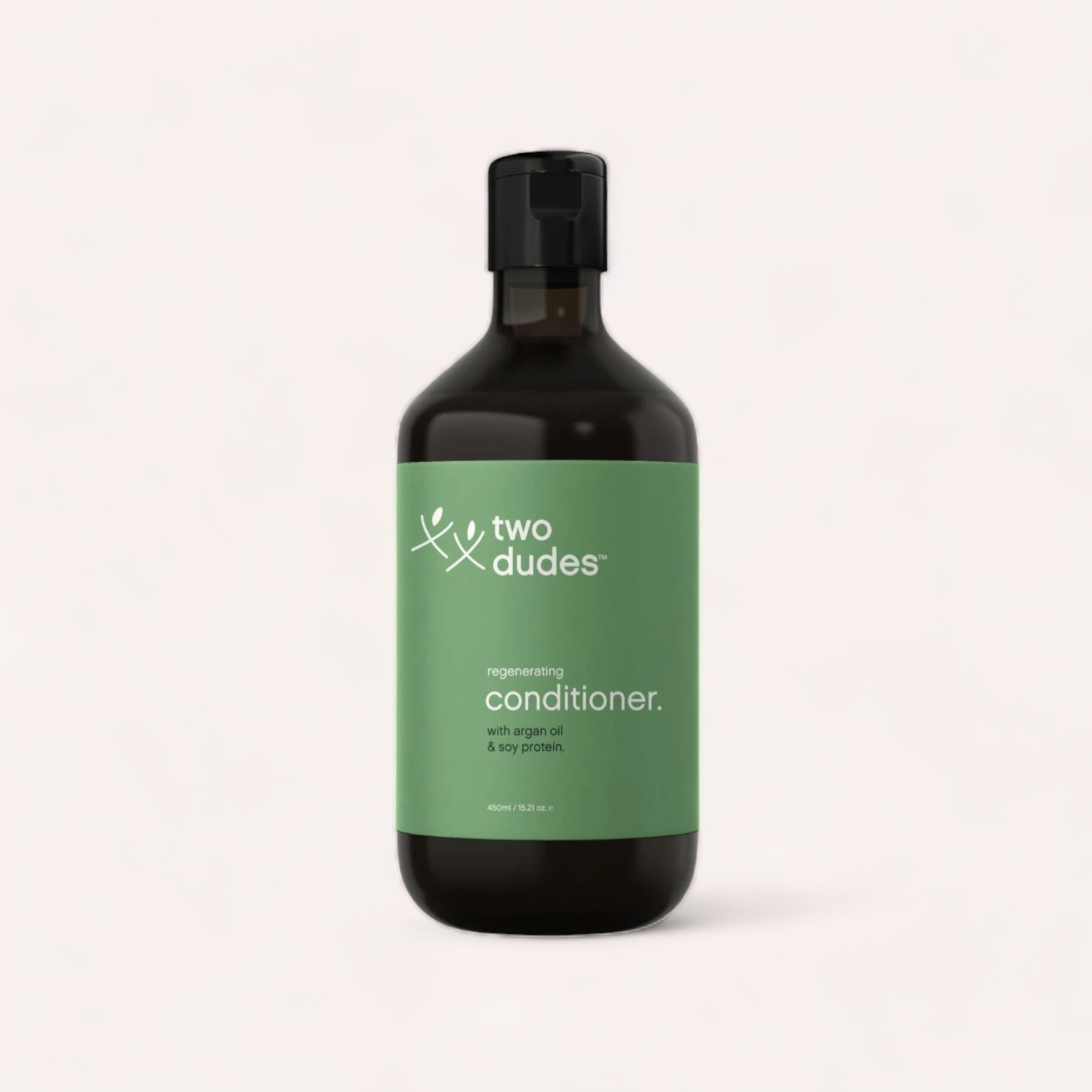 A minimalist-designed bottle of Conditioner by Two Dudes with argan oil and soy protein against a plain background.