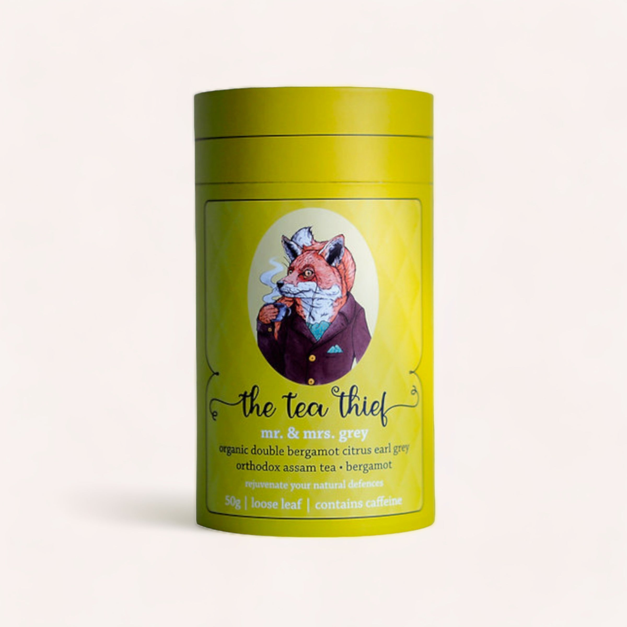 A tin of "Mr & Mrs Grey" loose leaf Earl Grey tea by The Tea Thief with a whimsical illustration of a smartly dressed fox wearing a suit, promoting organic blends rich in antioxidants and flavored with citrus bergam.