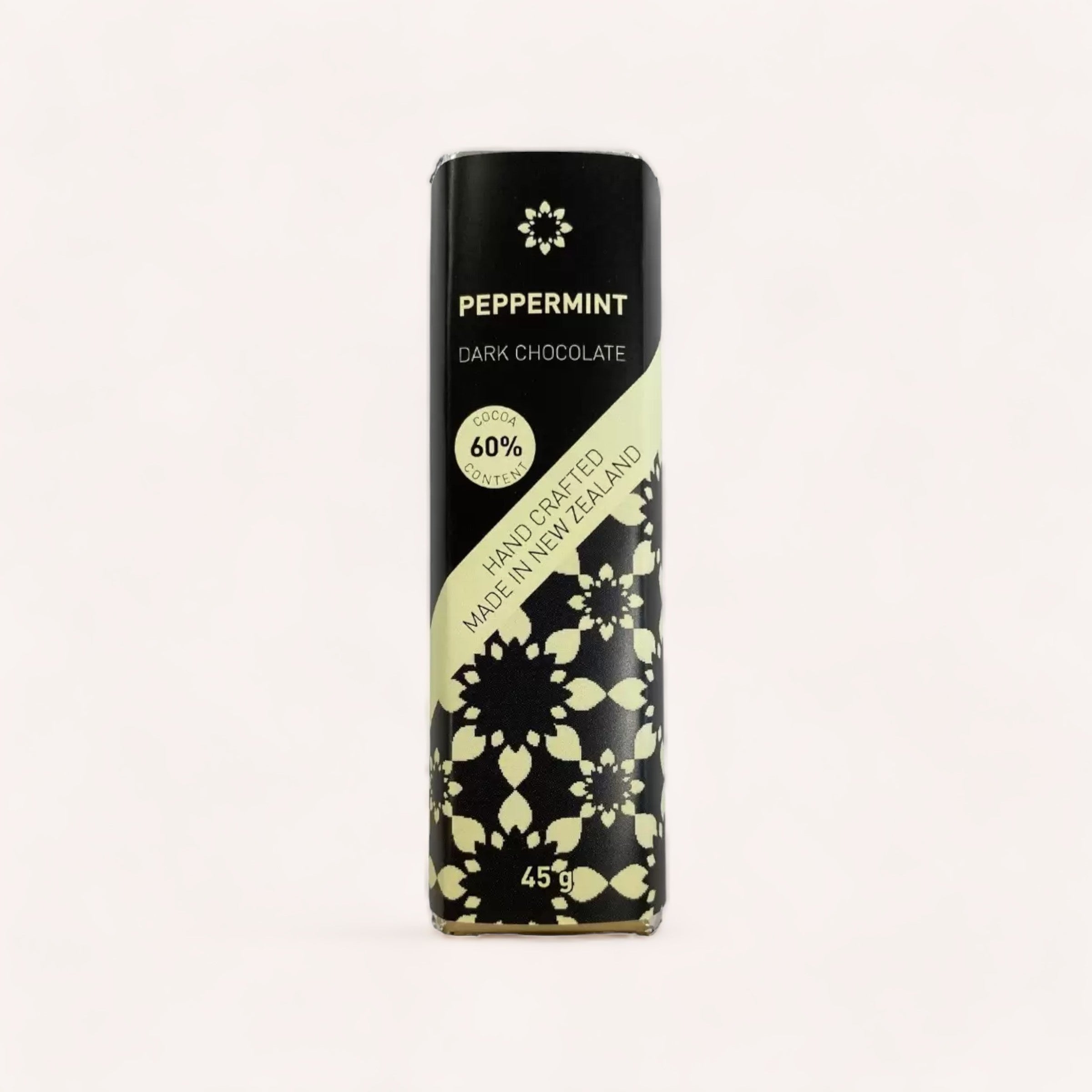 A product of New Zealand, the Peppermint Chocolate bar by Chocolate Traders with 60% cacao content is handcrafted and vegan, wrapped in elegant black packaging with floral patterns, weighing 45g.