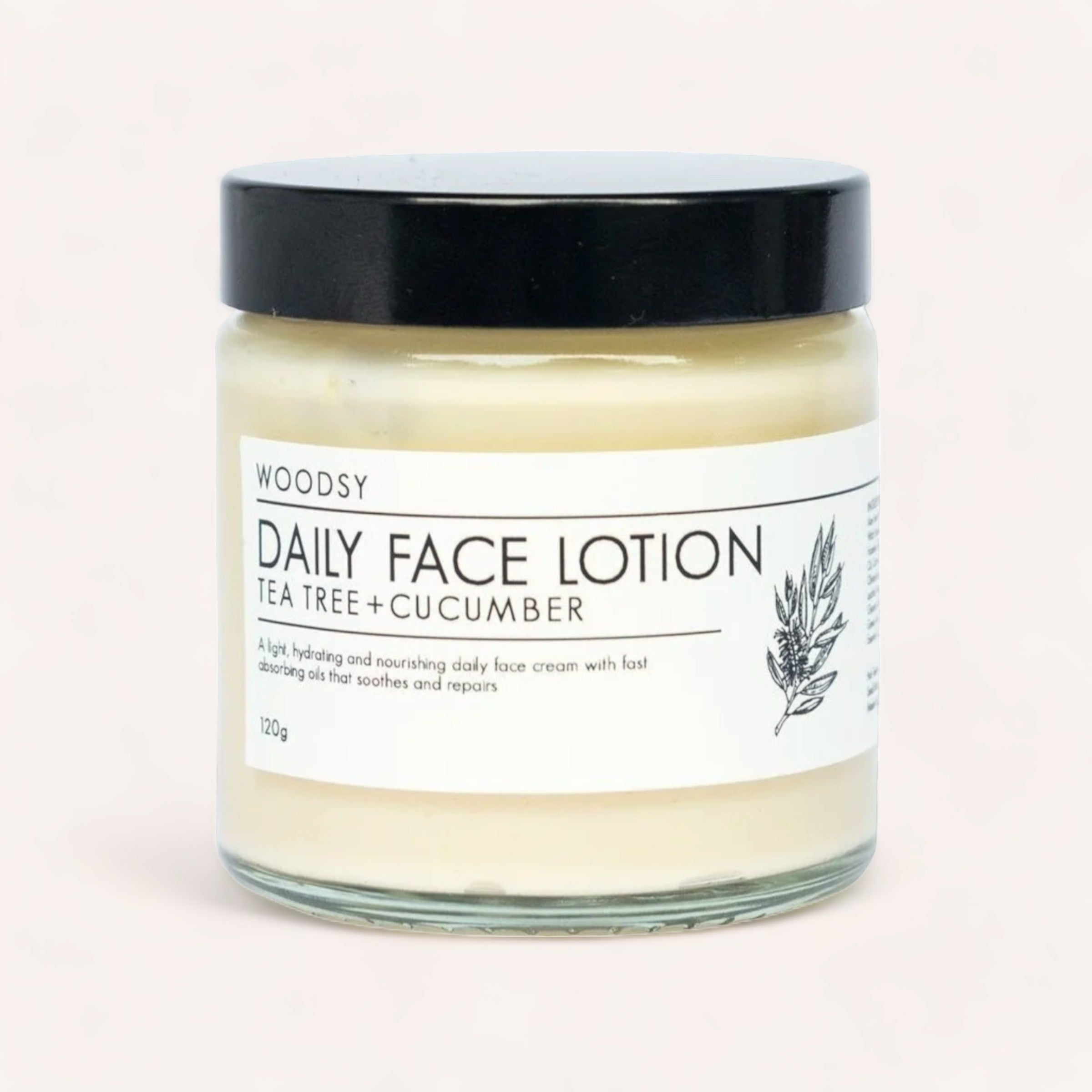 A jar of Daily Face Lotion - Tea Tree & Cucumber by Woodsy Botanics on a plain background.