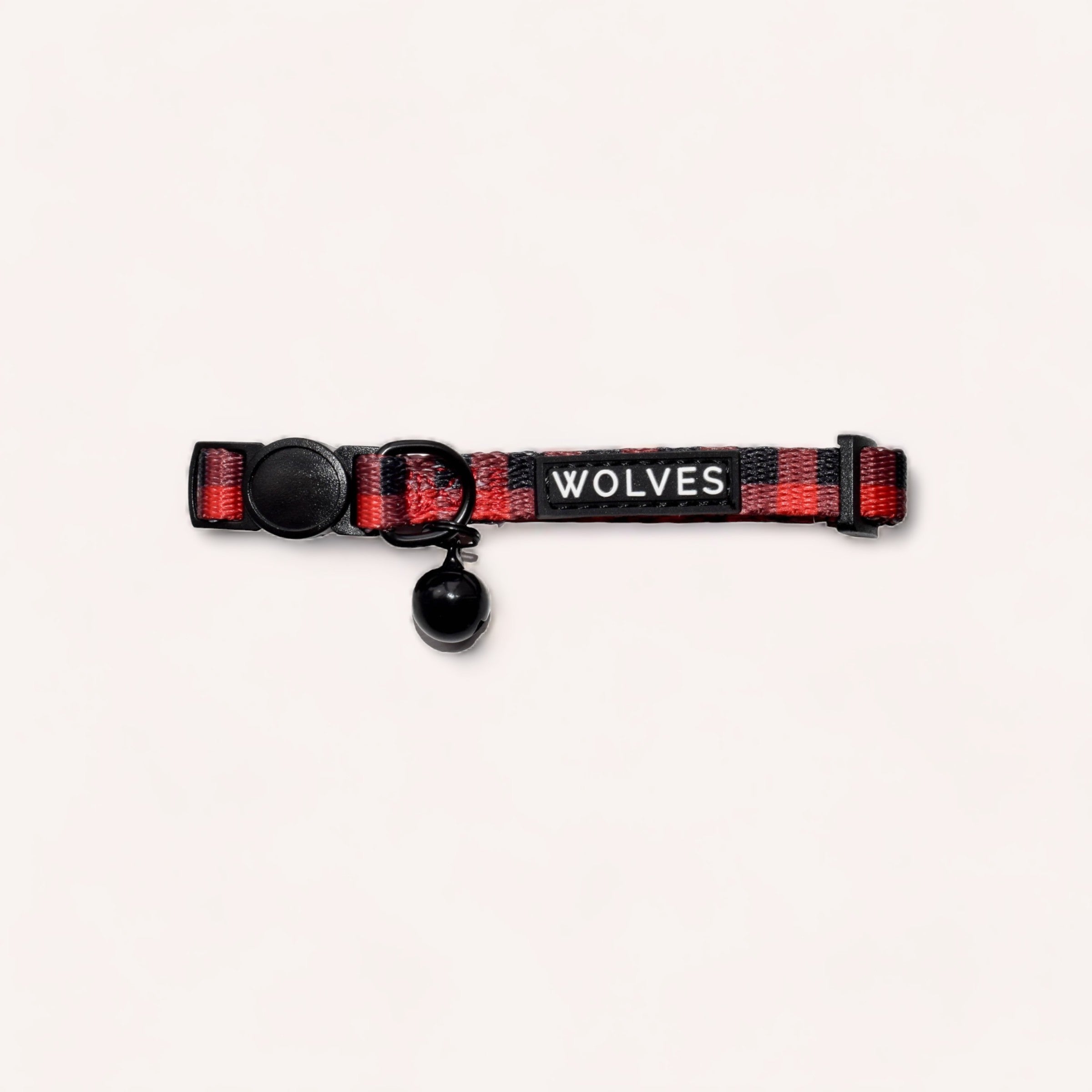 A red and black adjustable dog collar with a breakaway buckle, featuring the word "Buffalo" on a label by Wolves of Wellington.