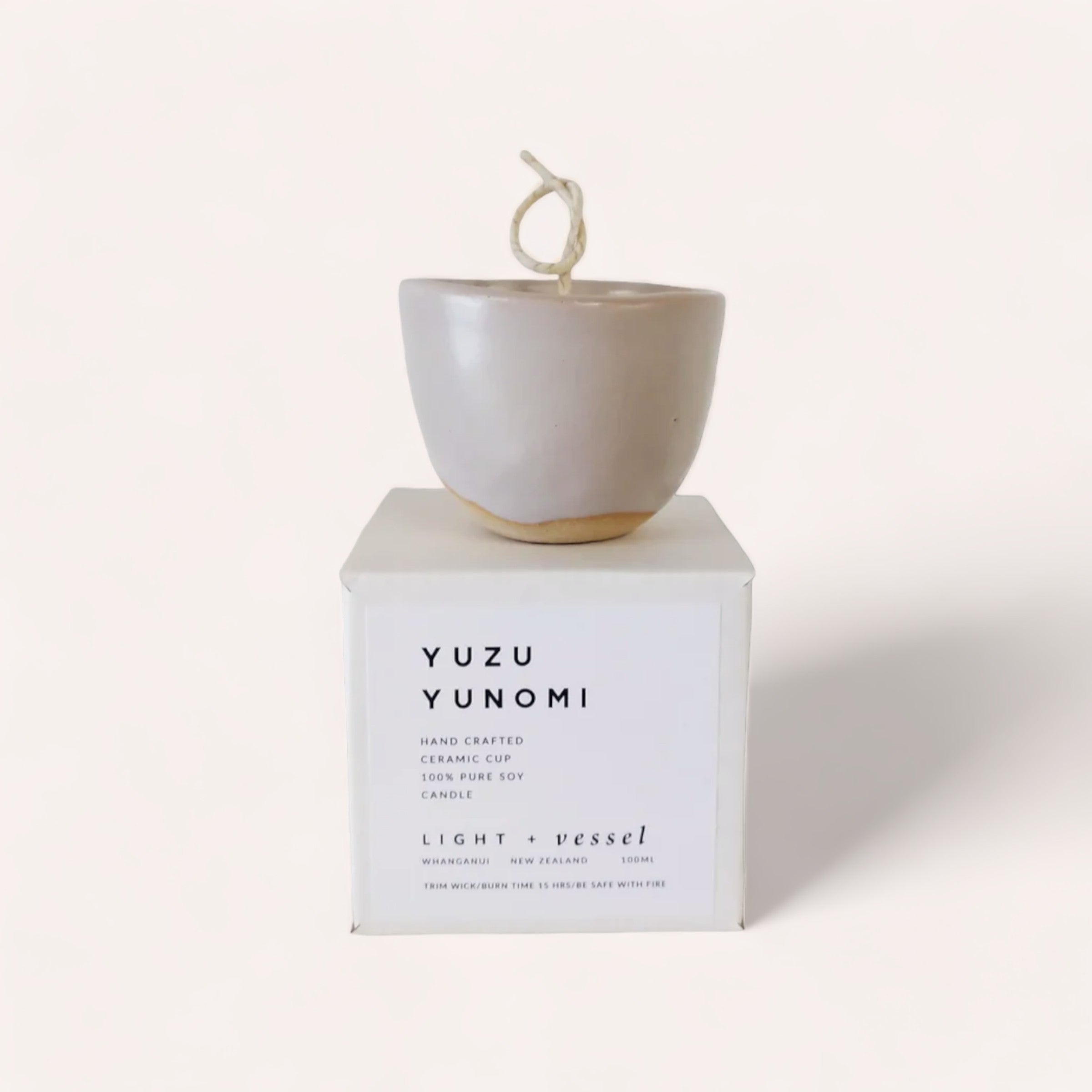 A hand-crafted ceramic Japanese tea cup Yuzu Candle by Light + Vessel soy candle, embodying minimalistic elegance.