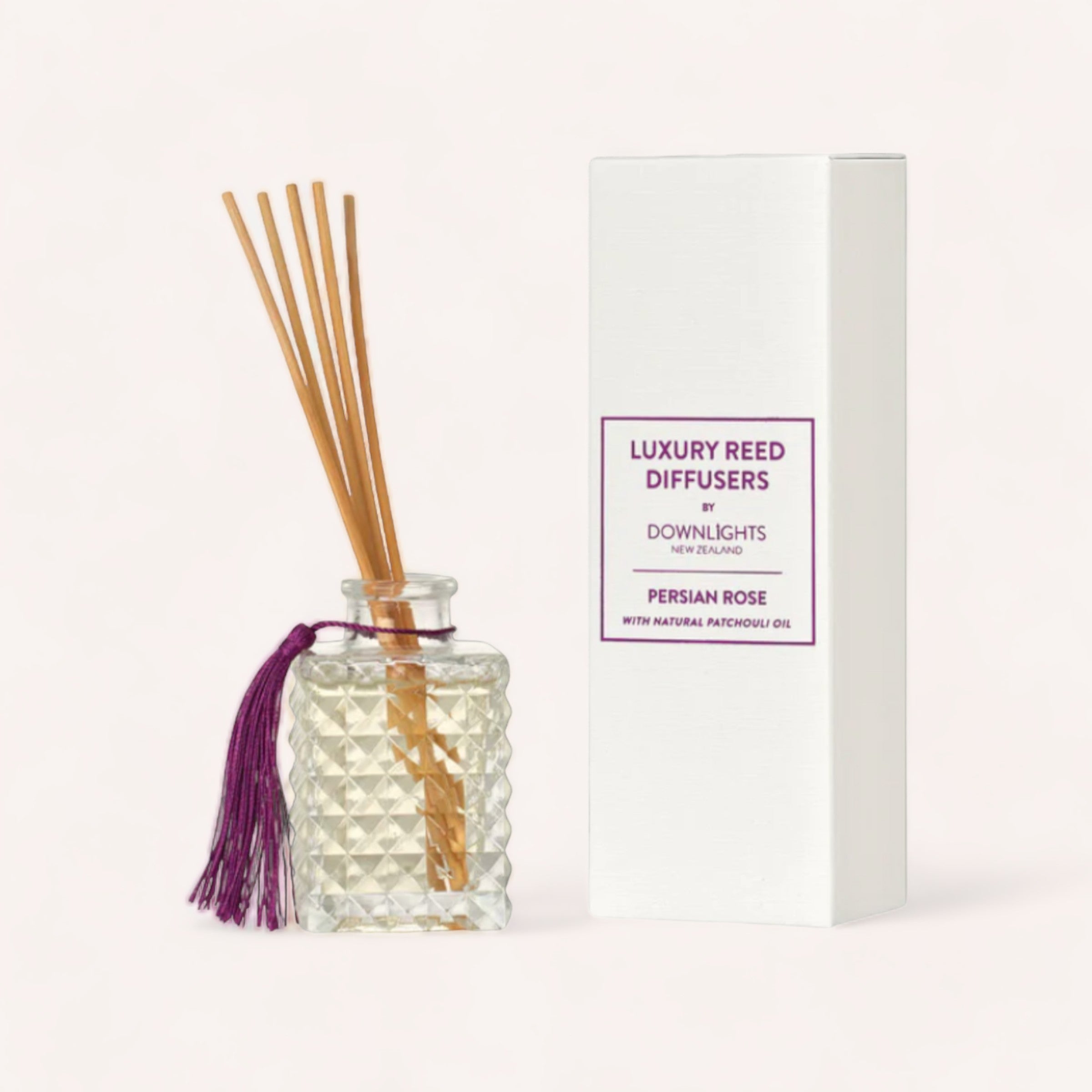 An elegant Persian Rose diffuser by Downlights with a brandied sweet fragrance, displayed next to its packaging.
