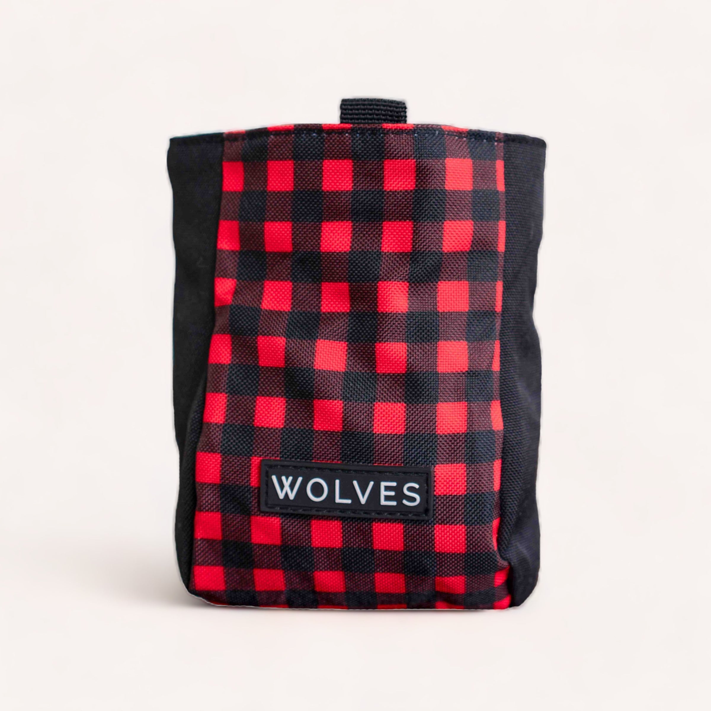 A durable red and black checkered Buffalo Treat Pouch with the word "wolves" on a label by Wolves of Wellington.