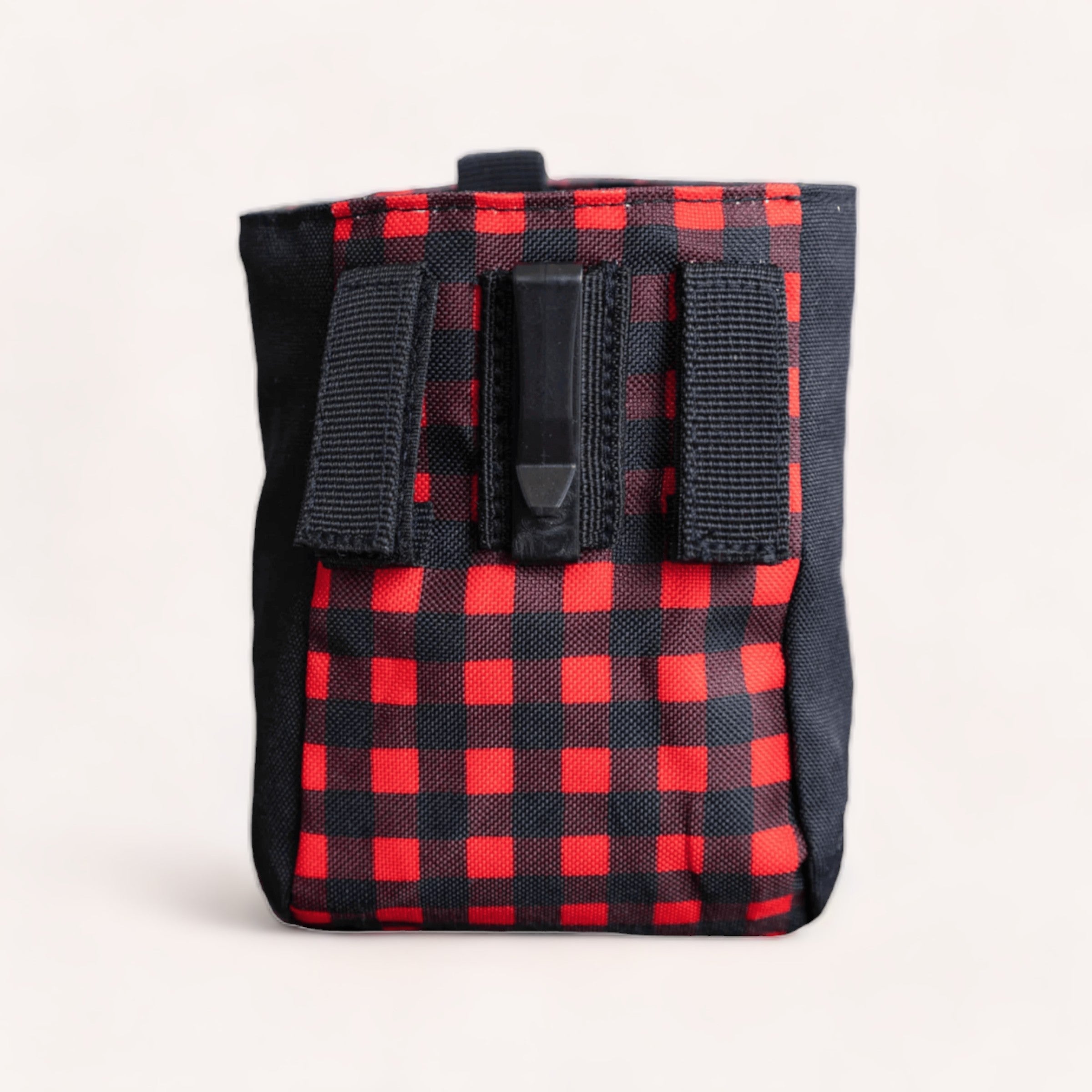 A red and black checkered, durable backpack with a front Velcro flap and Buffalo Treat Pouch on a neutral background by Wolves of Wellington.