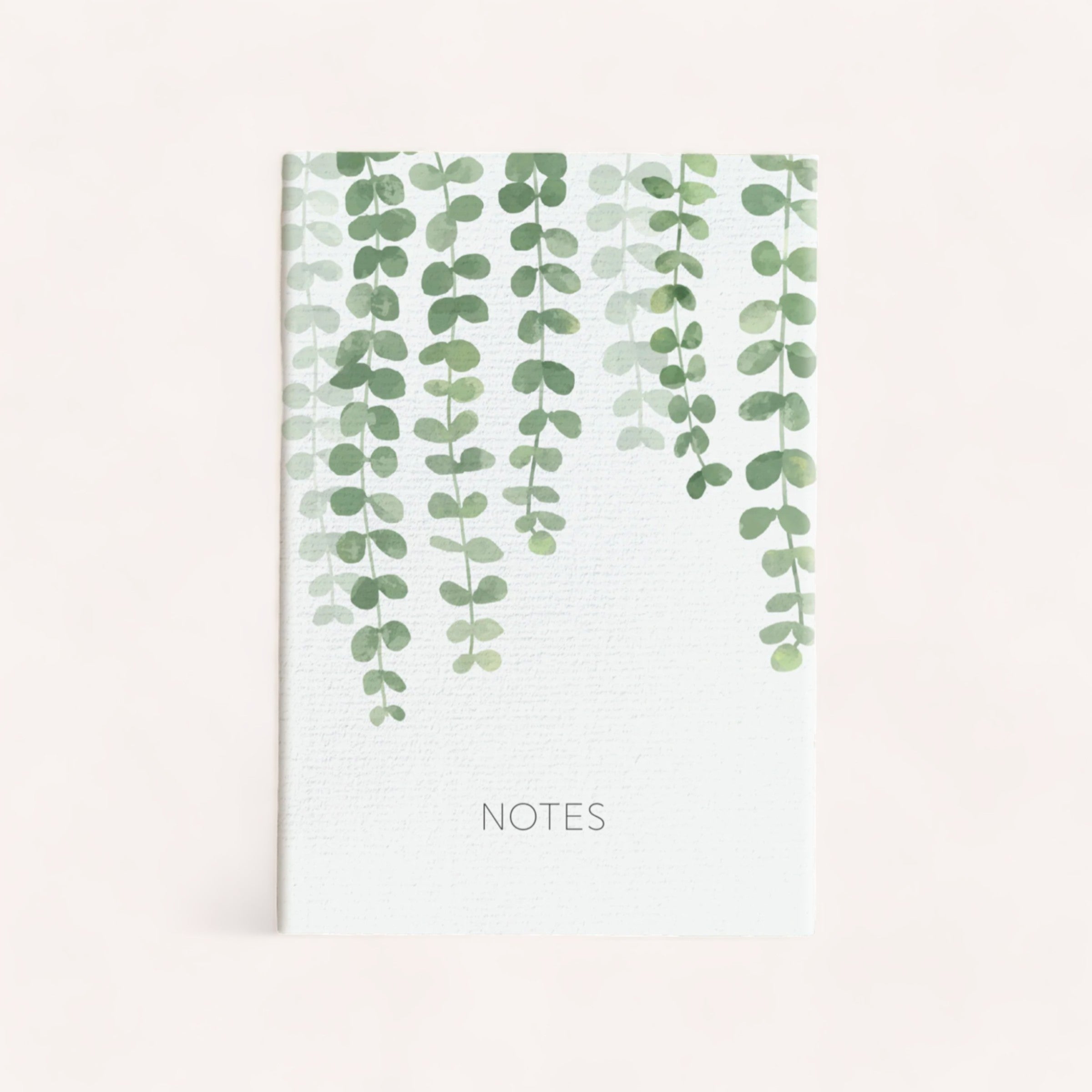A serene, unlined Leaf Notebook with a botanical design featuring cascading green leaves on a clean, white background by Ink Bomb.