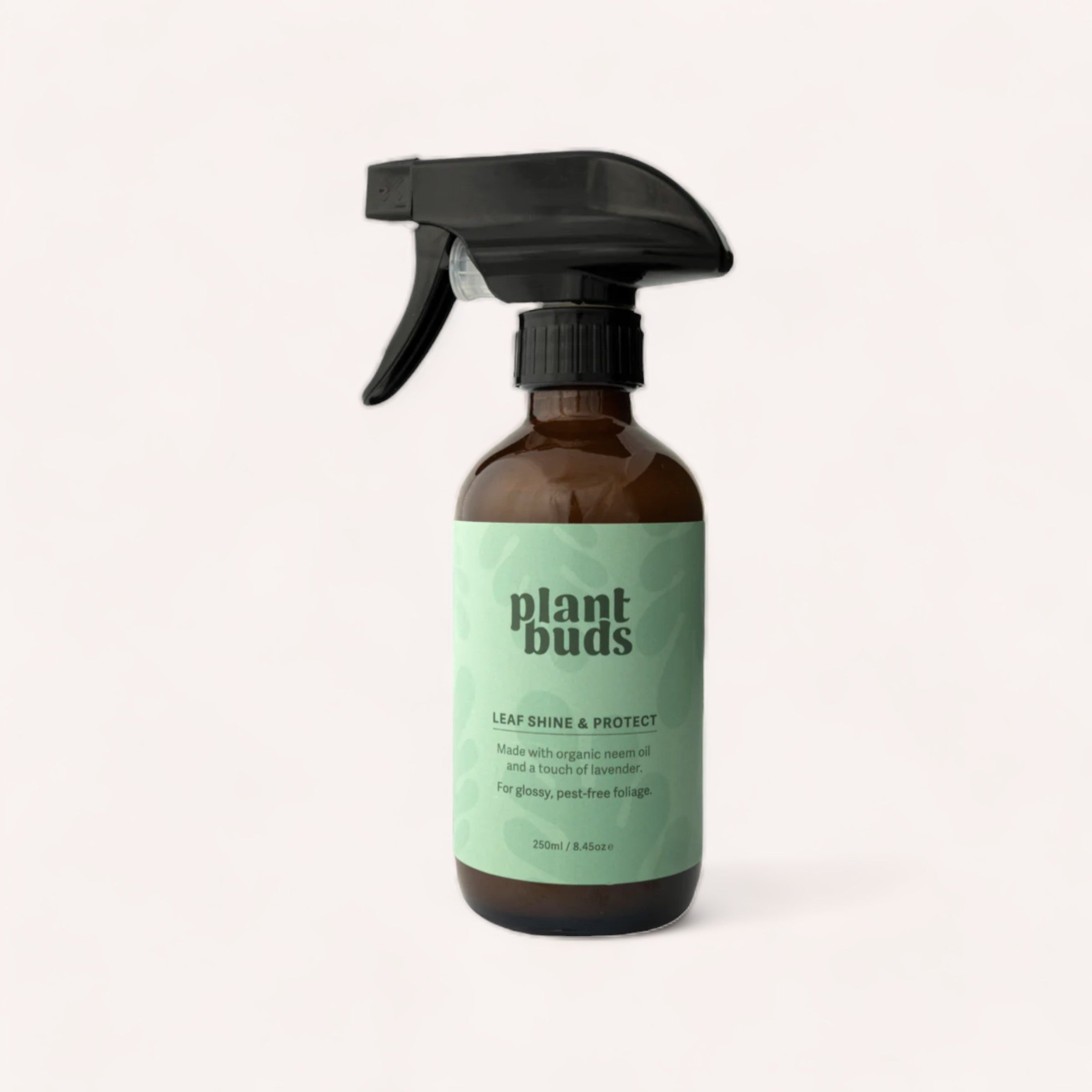 A spray bottle labeled "Leaf Shine & Protect by Plantbuds" for leaf shine and protection, contains organic neem oil, against a clean white background.