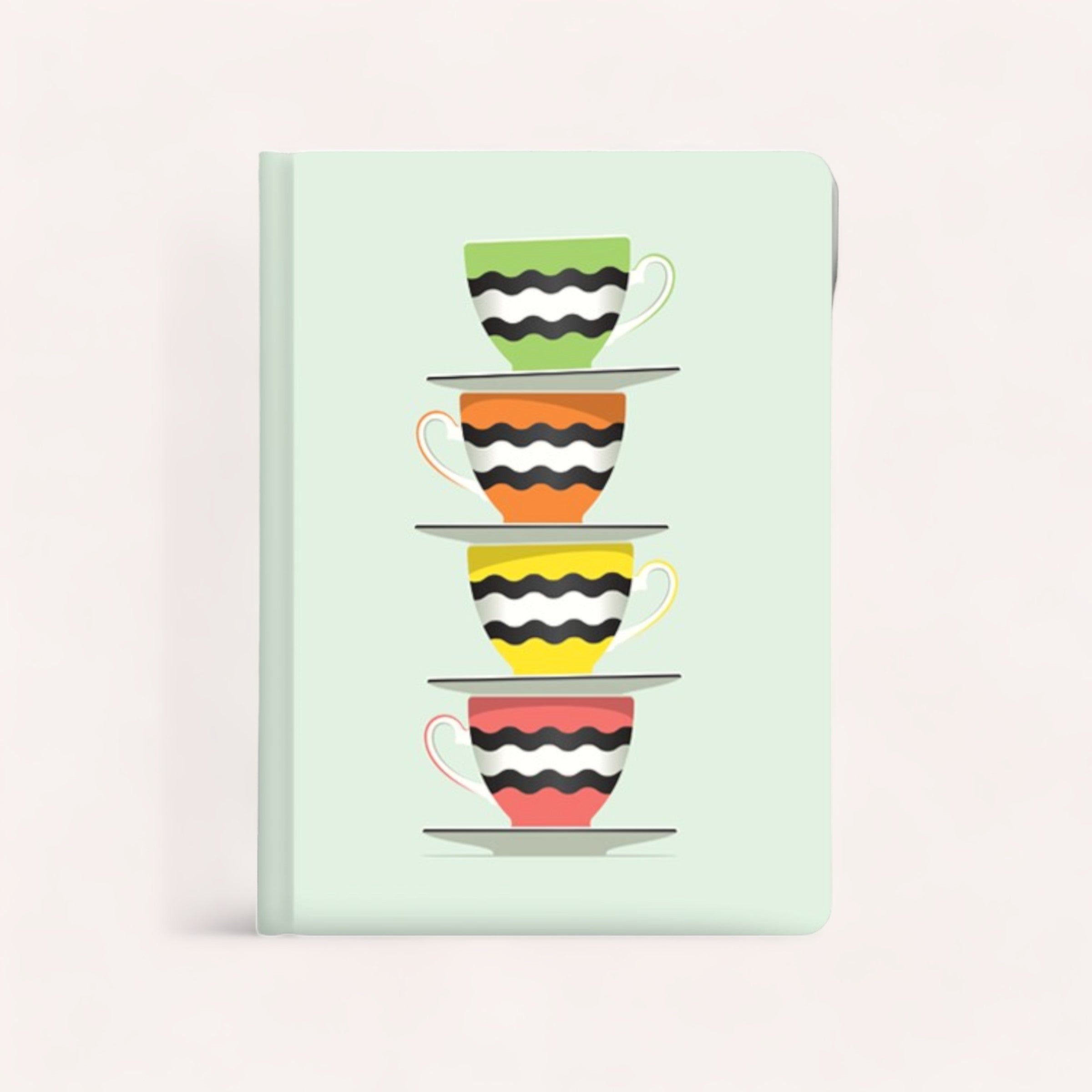 A stack of four colorful, striped teacups depicted on the pastel green cover of a Licorice Journal by Glenn Jones Accessories.