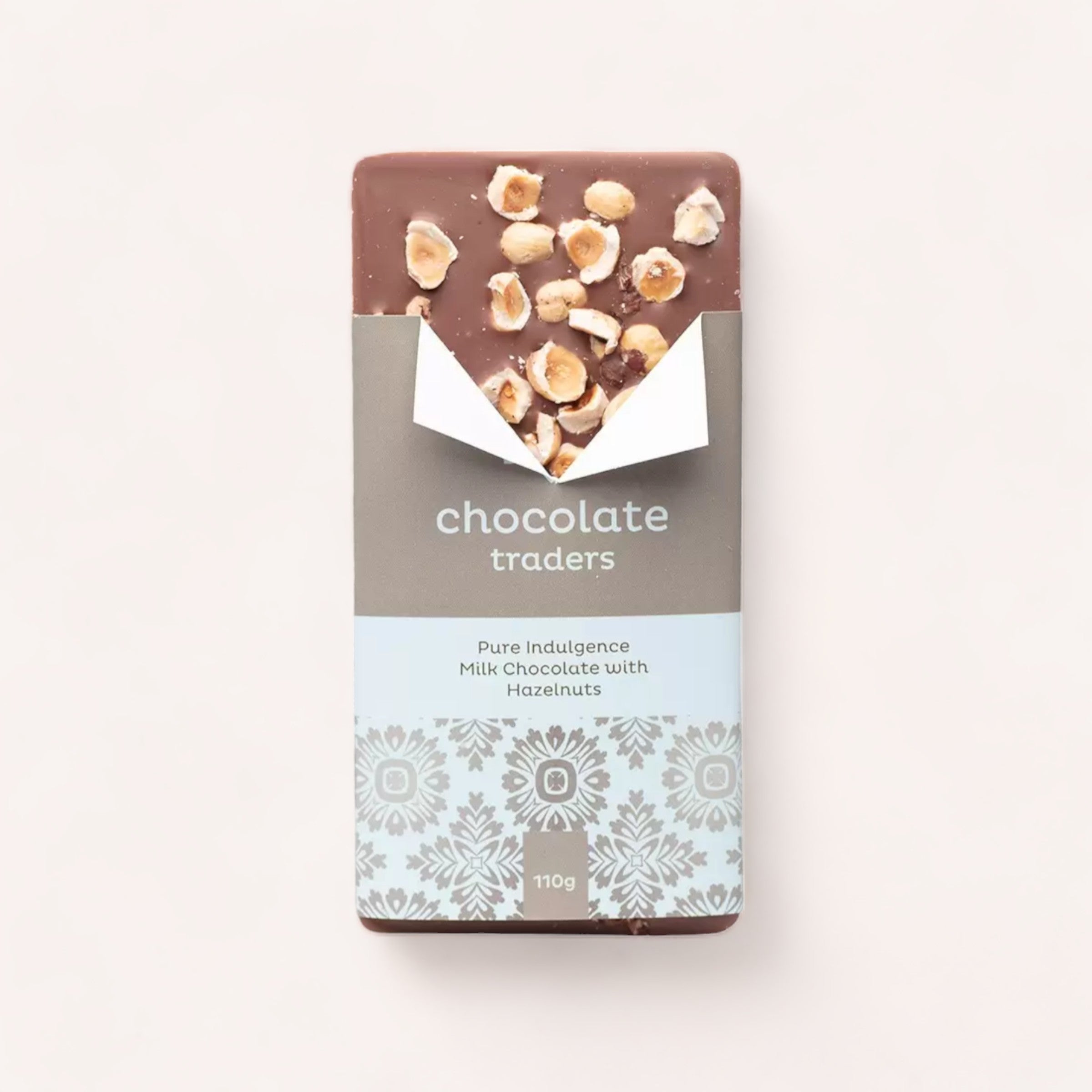 A hand-crafted bar of Pure Indulgence Hazelnut chocolate by Chocolate Traders, in elegant packaging, presented on a neutral background—inviting a taste of pure indulgence.