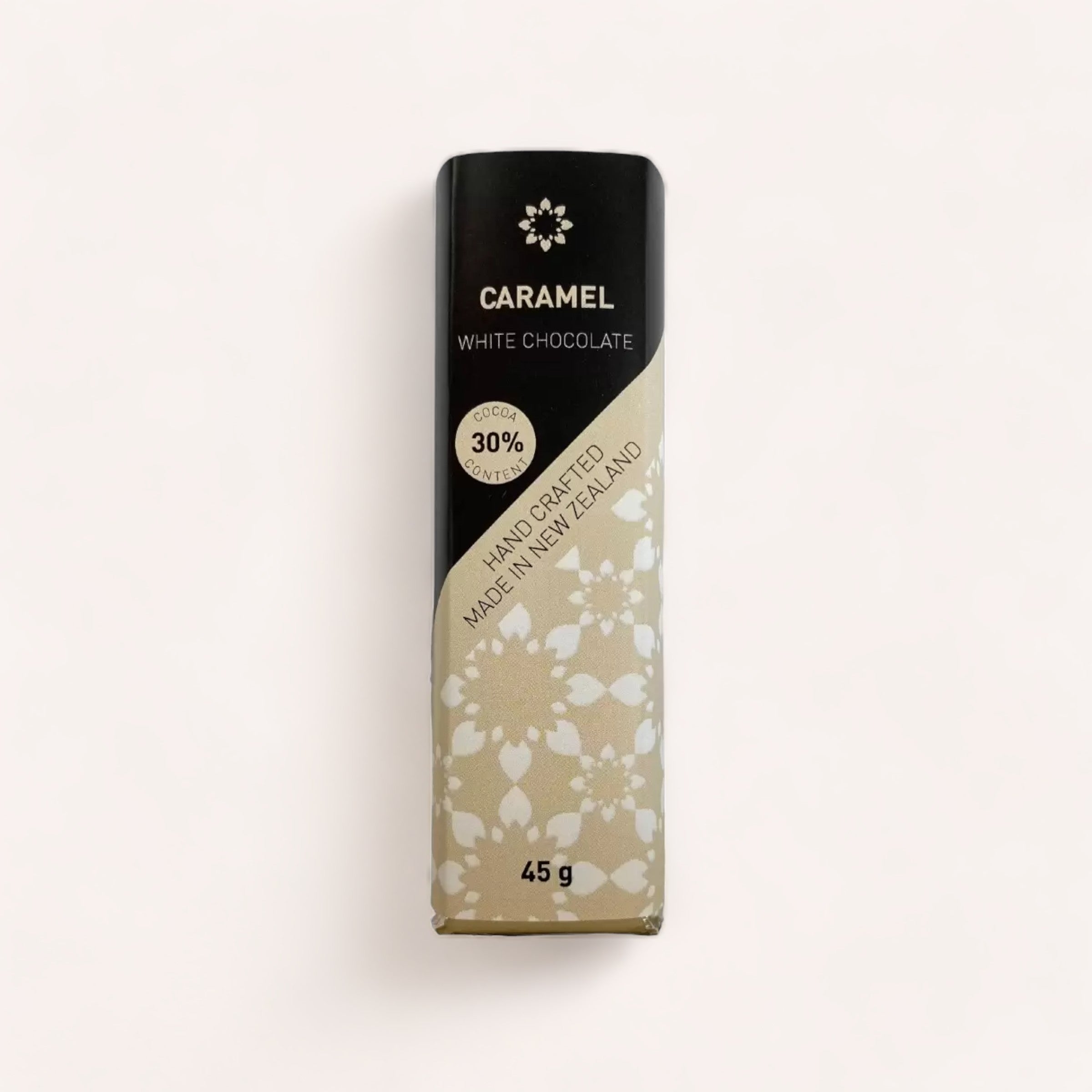 A Caramel White Chocolate bar by Chocolate Traders with a 30% cocoa content, elegantly wrapped and weighing 45 grams. Product of New Zealand.