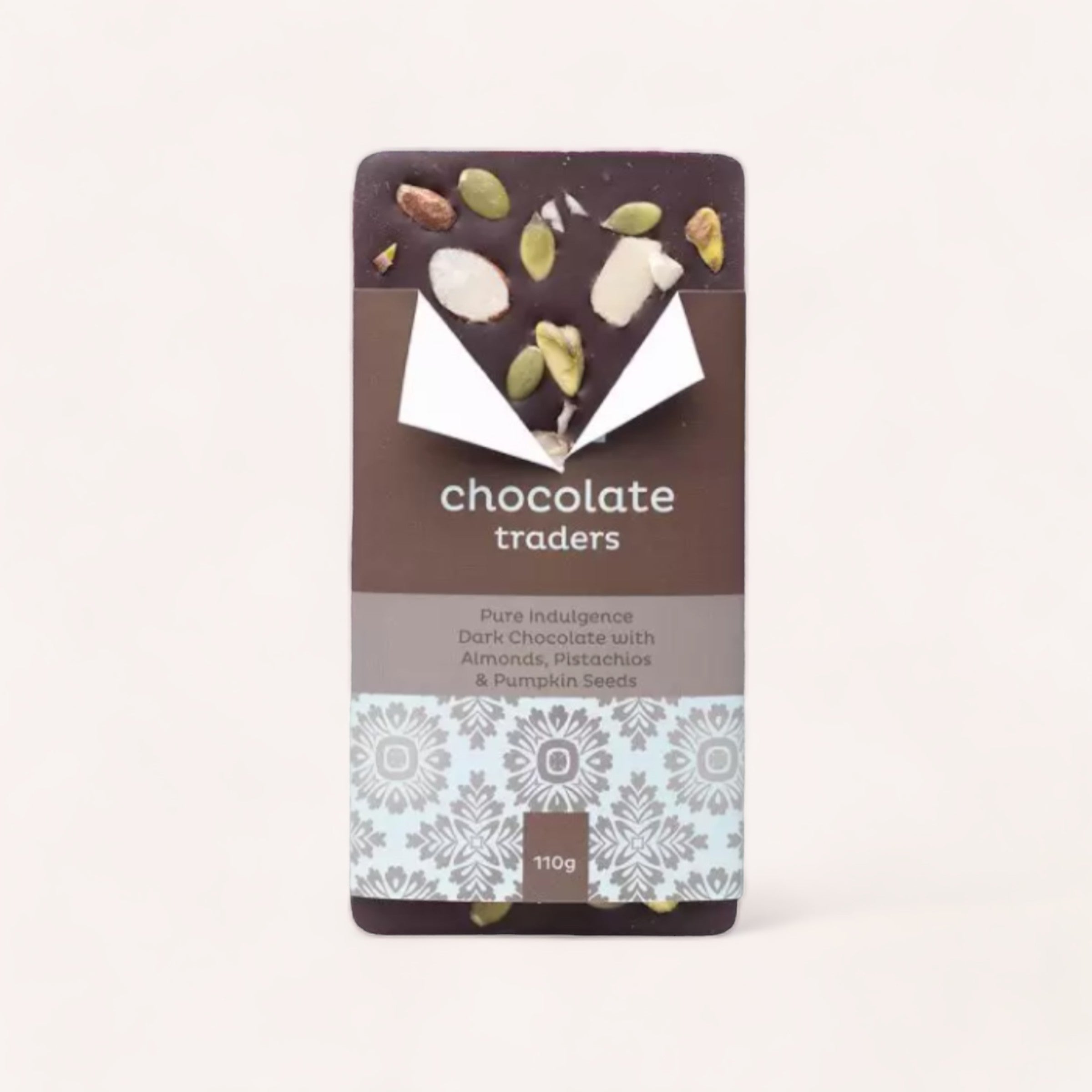 A hand-crafted Pure Indulgence Almonds, Pistachios & Pumpkin Seeds chocolate bar by Chocolate Traders in elegant packaging, promising a blend of pure indulgence with a hint of artisanal flair.
