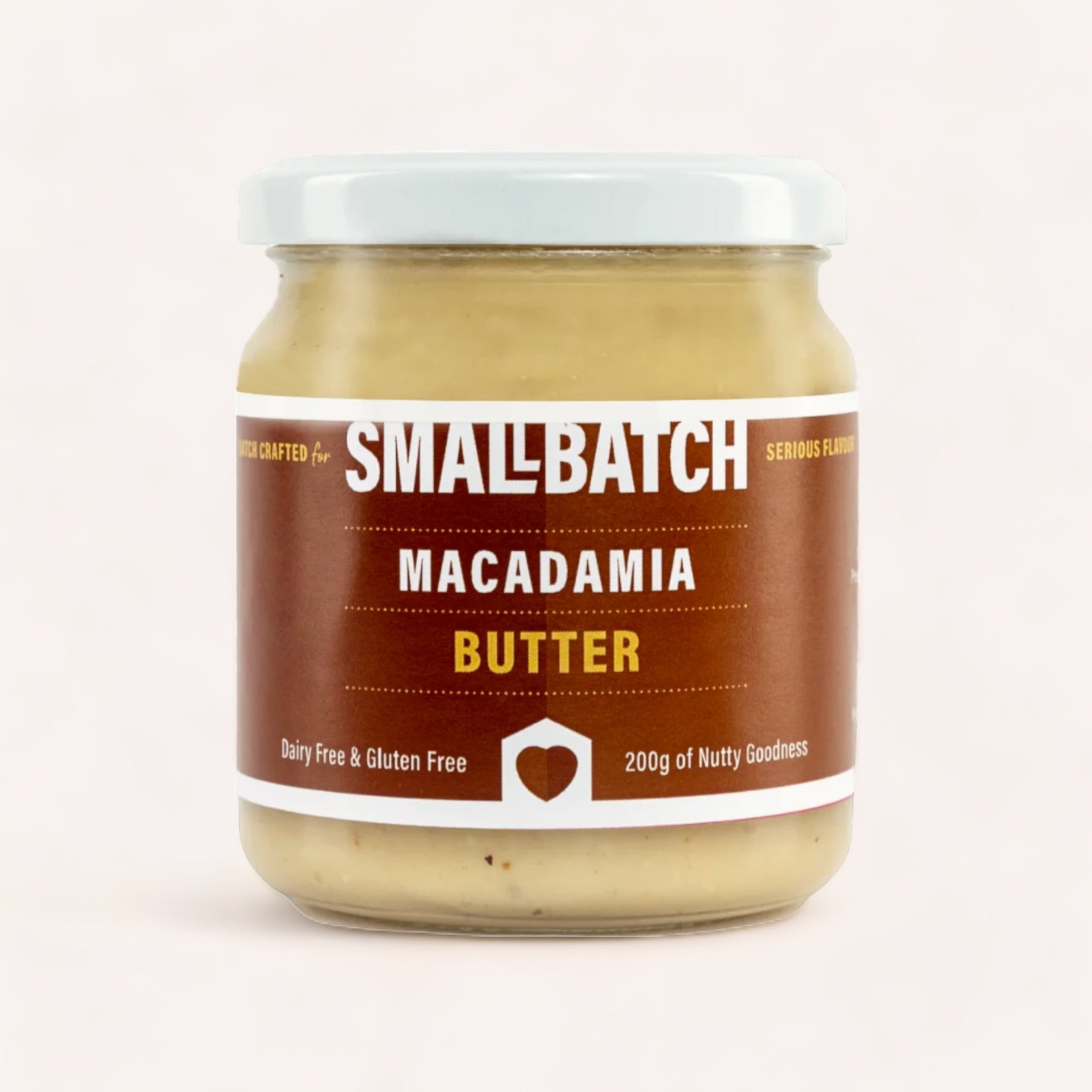 A jar of Macadamia Butter by Smallbatch made in Mount Maunganui against a neutral background, highlighting its dairy-free and gluten-free qualities with a tagline that reads "200g of nutty.
