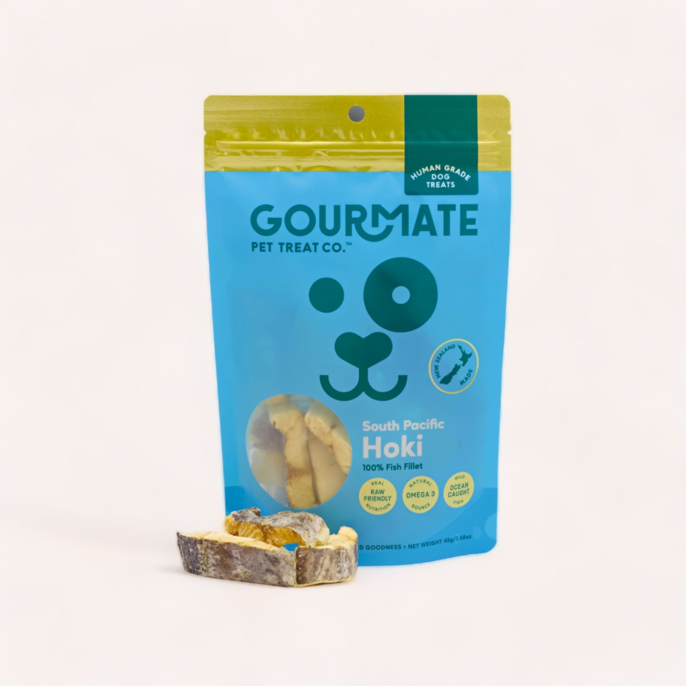 A packet of Gourmate Pet Treat Co. South Pacific Hoki Treats, rich in omega-3, against a plain background, with a few treats displayed in front.