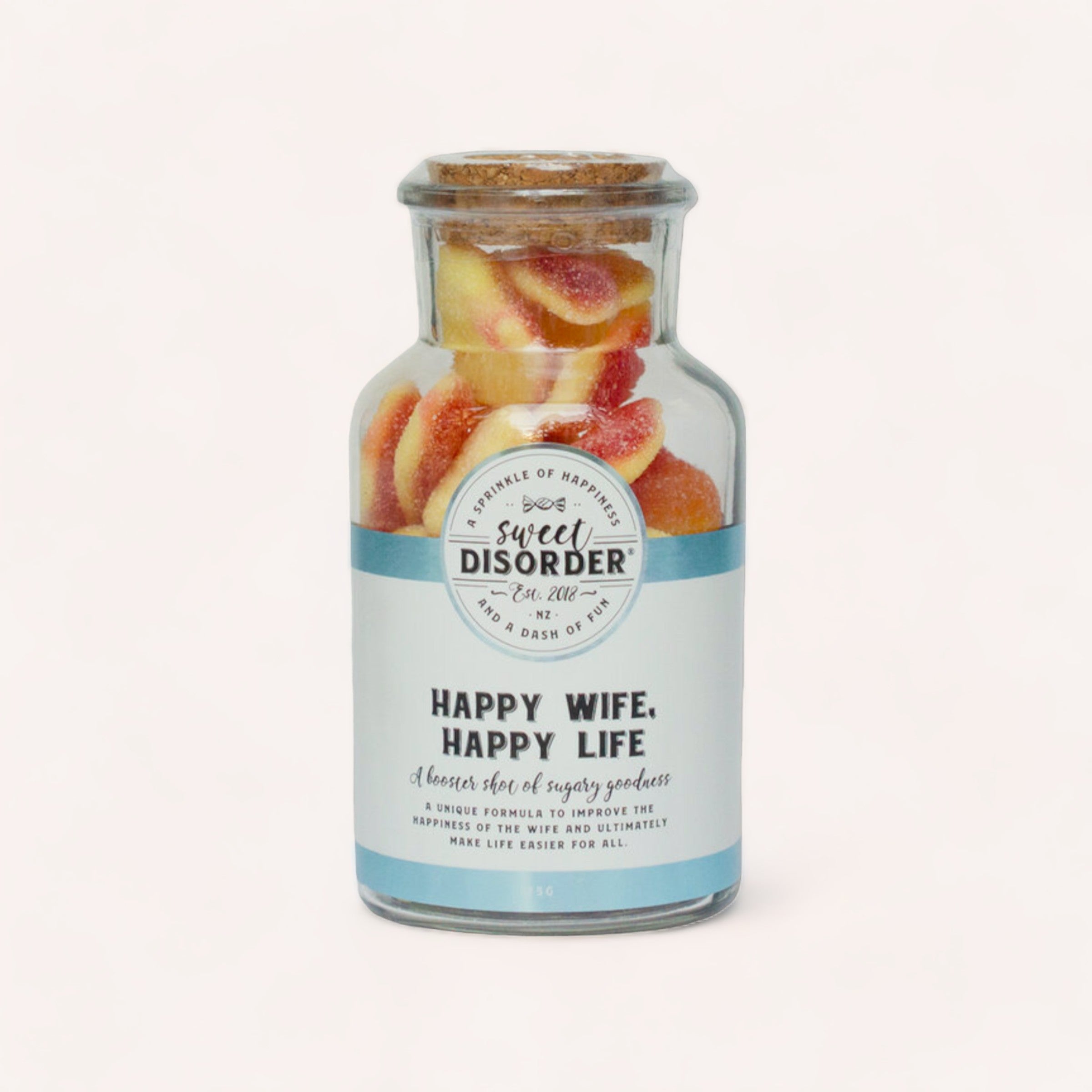 A jar of love infused sour peach hearts labeled "Happy Wife, Happy Life Lollies" from Sweet Disorder, a humorous themed confectionery brand.