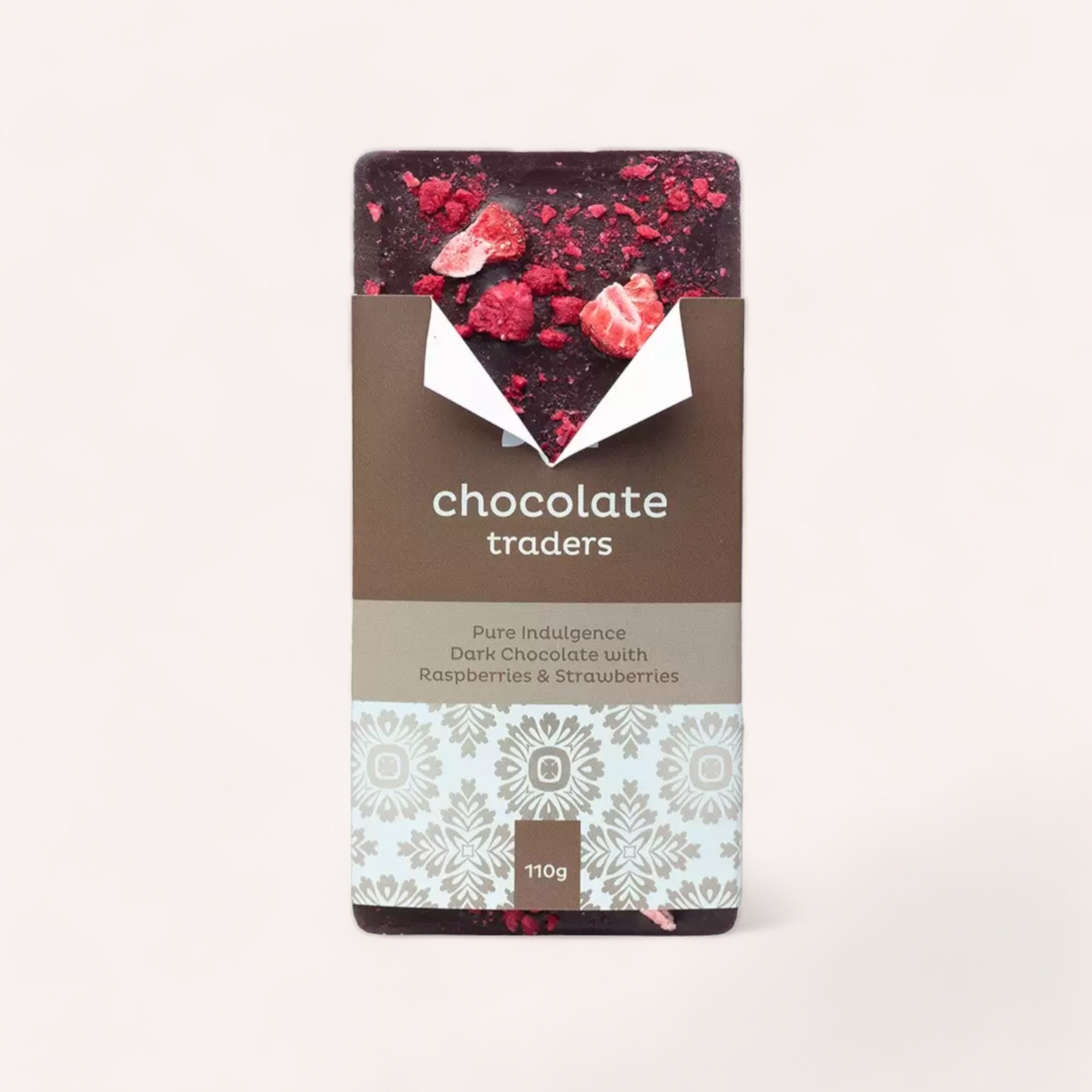 A bar of Pure Indulgence Raspberries & Strawberries by Chocolate Traders, elegantly presented in a wrapper as a gift, hinting at a rich and fruity taste experience.