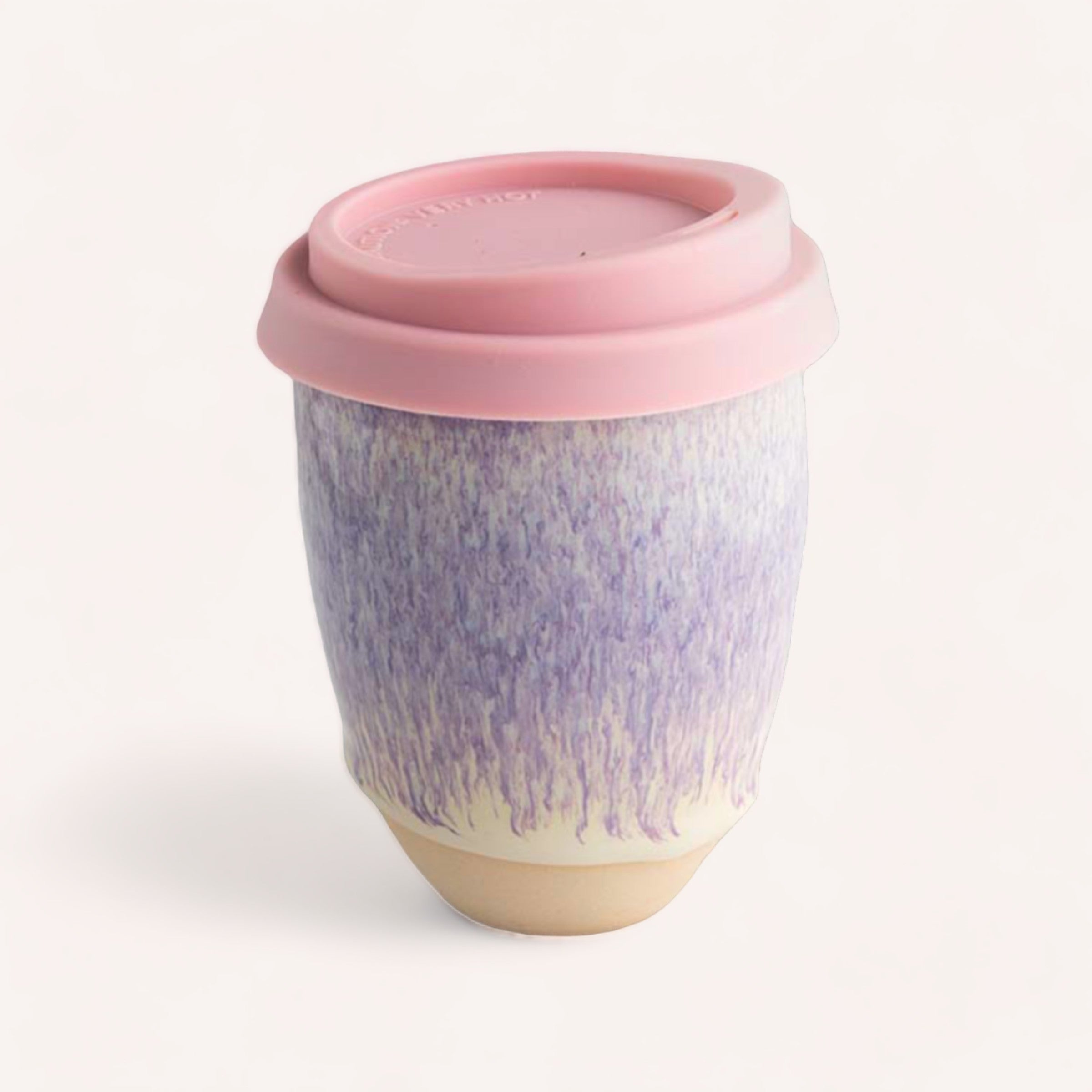 A handcrafted Ceramic Keep Cup by Sam Mayell with a lavender and white gradient design and a pink silicone lid, against a plain white background.