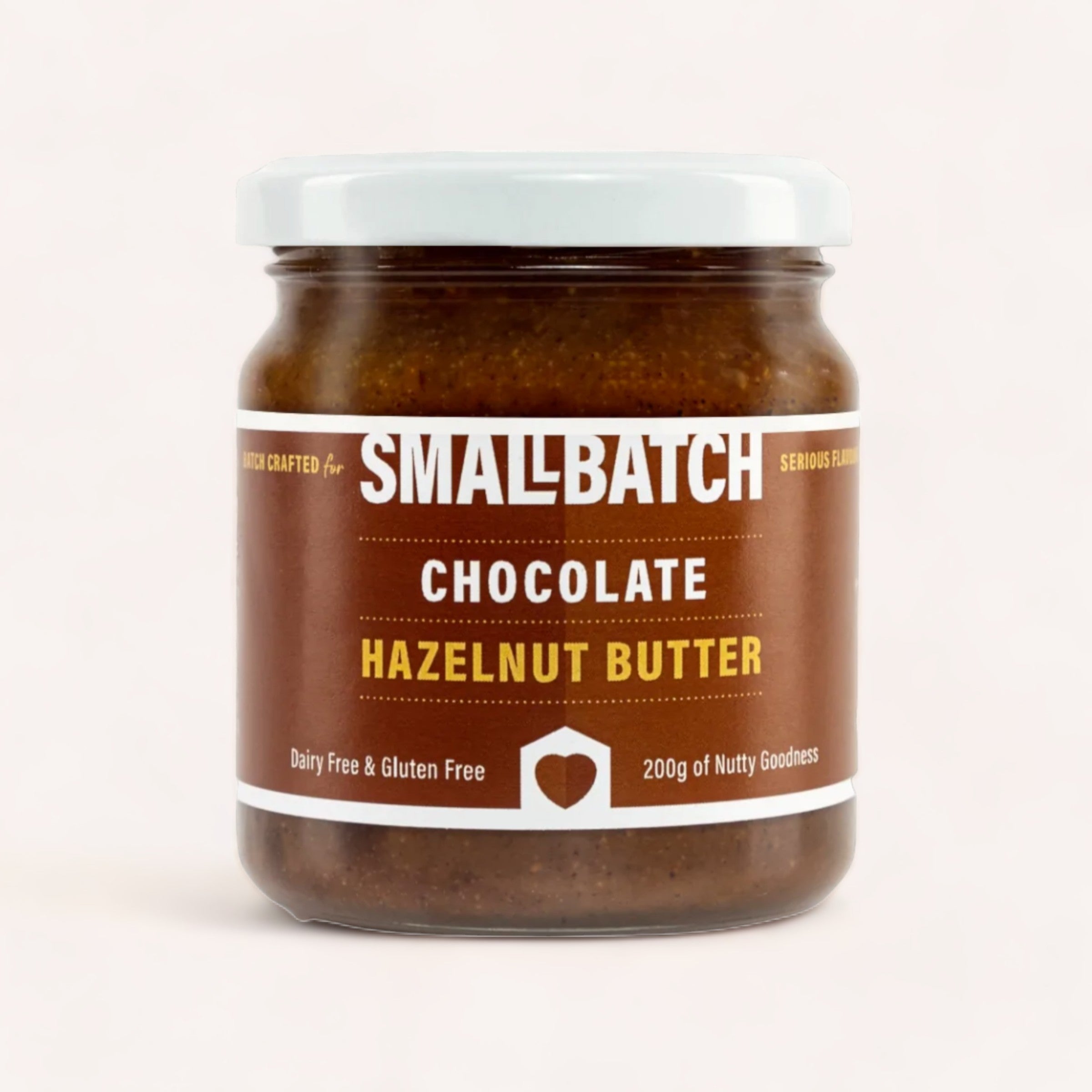 A jar of Chocolate Hazelnut Butter by Smallbatch, made in Mount Maunganui, highlighting its artisanal quality with a tagline "serious flavor," and indicating that it's dairy-free and gluten.