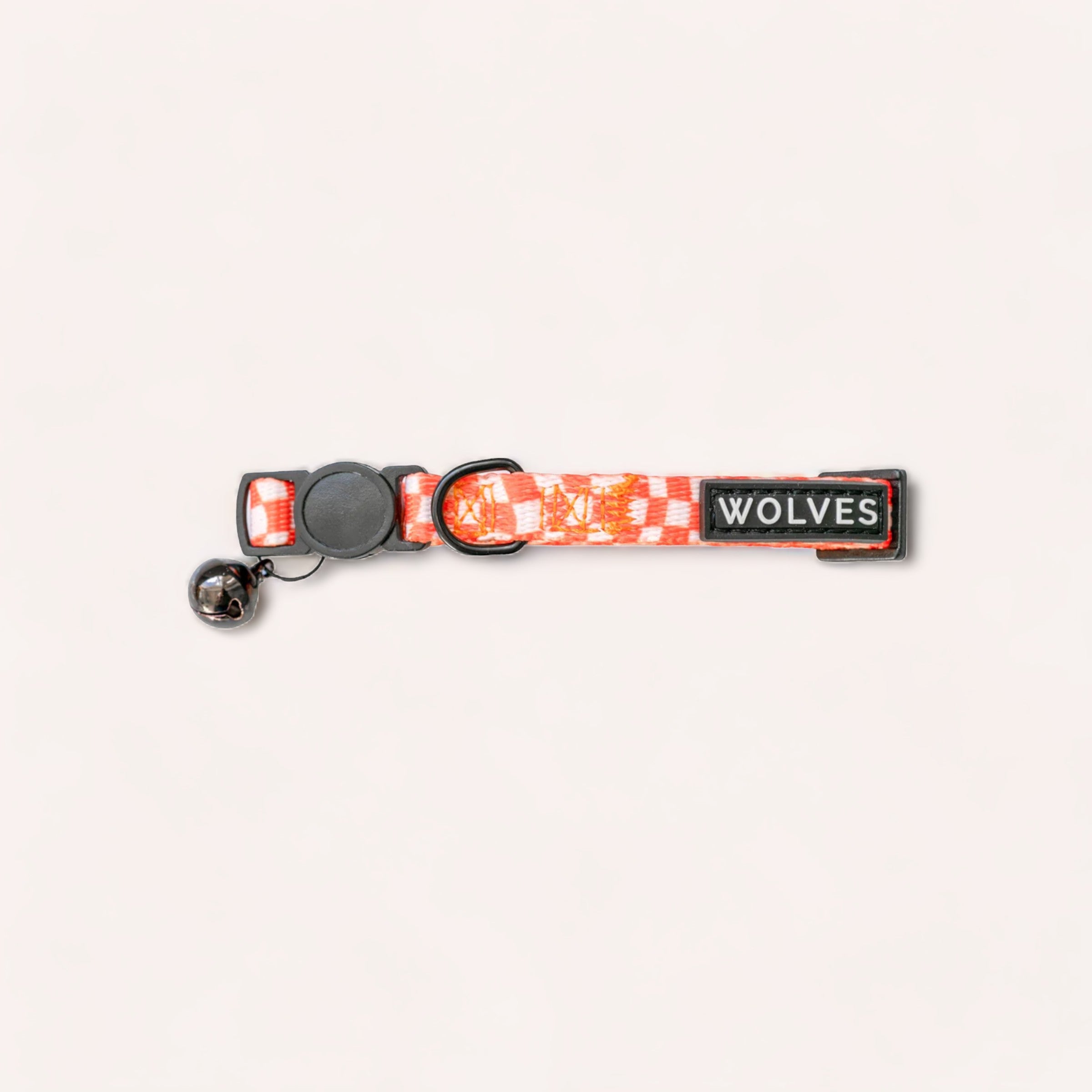 A red and gray canine collar with a camouflage pattern, featuring a breakaway buckle, a metal d-ring, and a patch that reads "wolves" called the Benji Cat Collar by Wolves of Wellington.