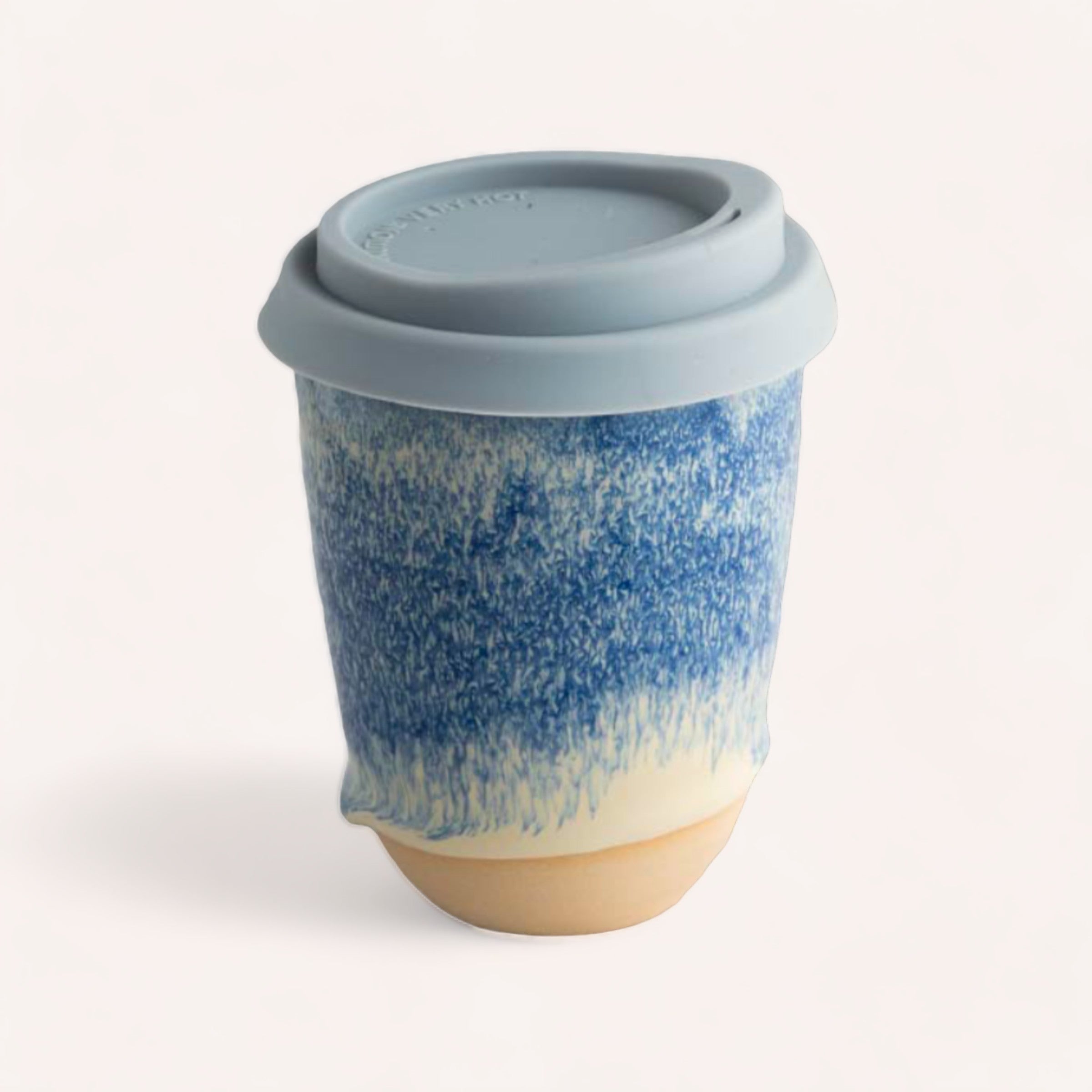 A Sam Mayell Ceramics ceramic keep cup with a unique blue textured design and an NZ sourced stoneware silicone lid.