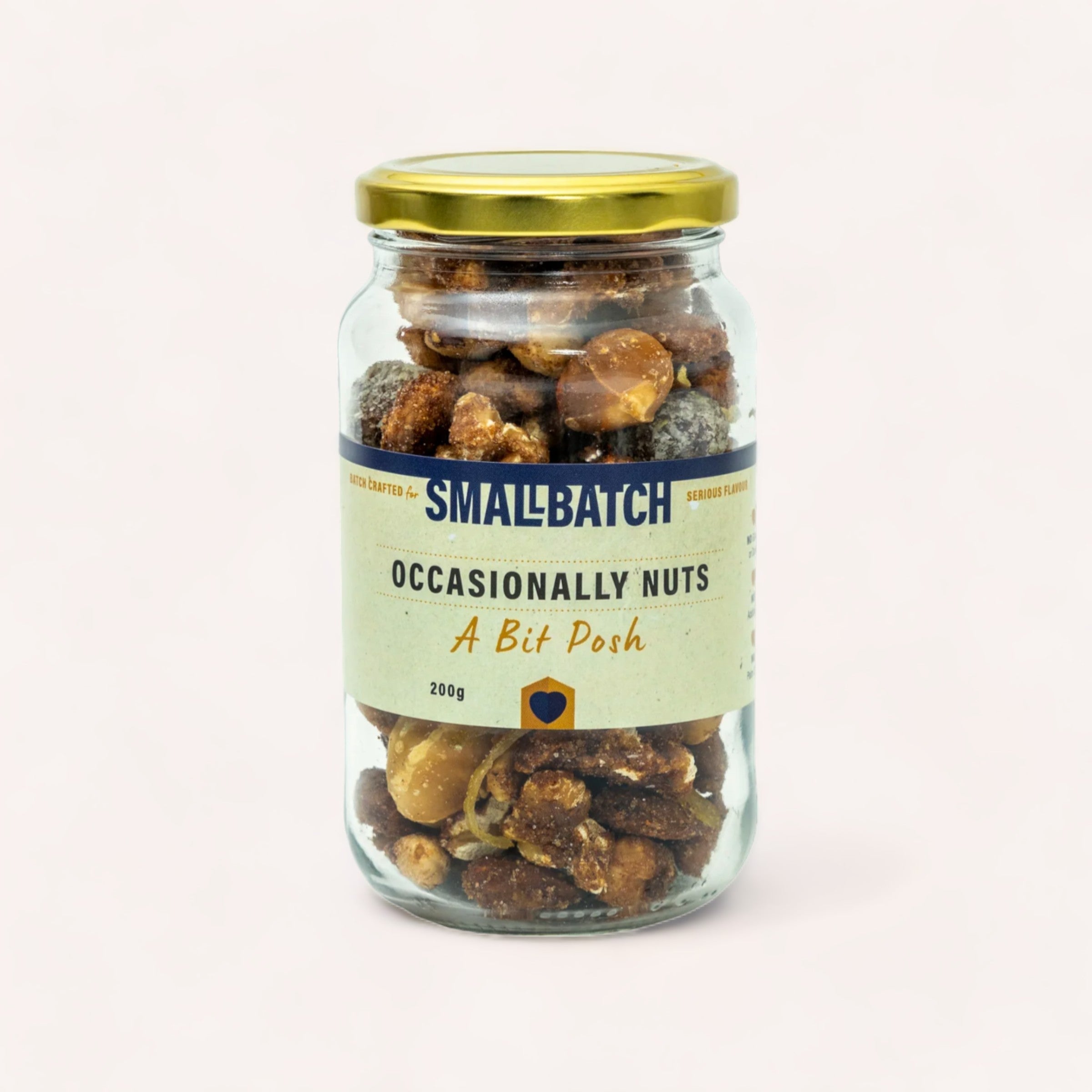 A glass jar filled with Mixed Nuts - A Bit Posh by Smallbatch, labeled "smallbatch occasionally nuts a bit posh," on a plain white background.