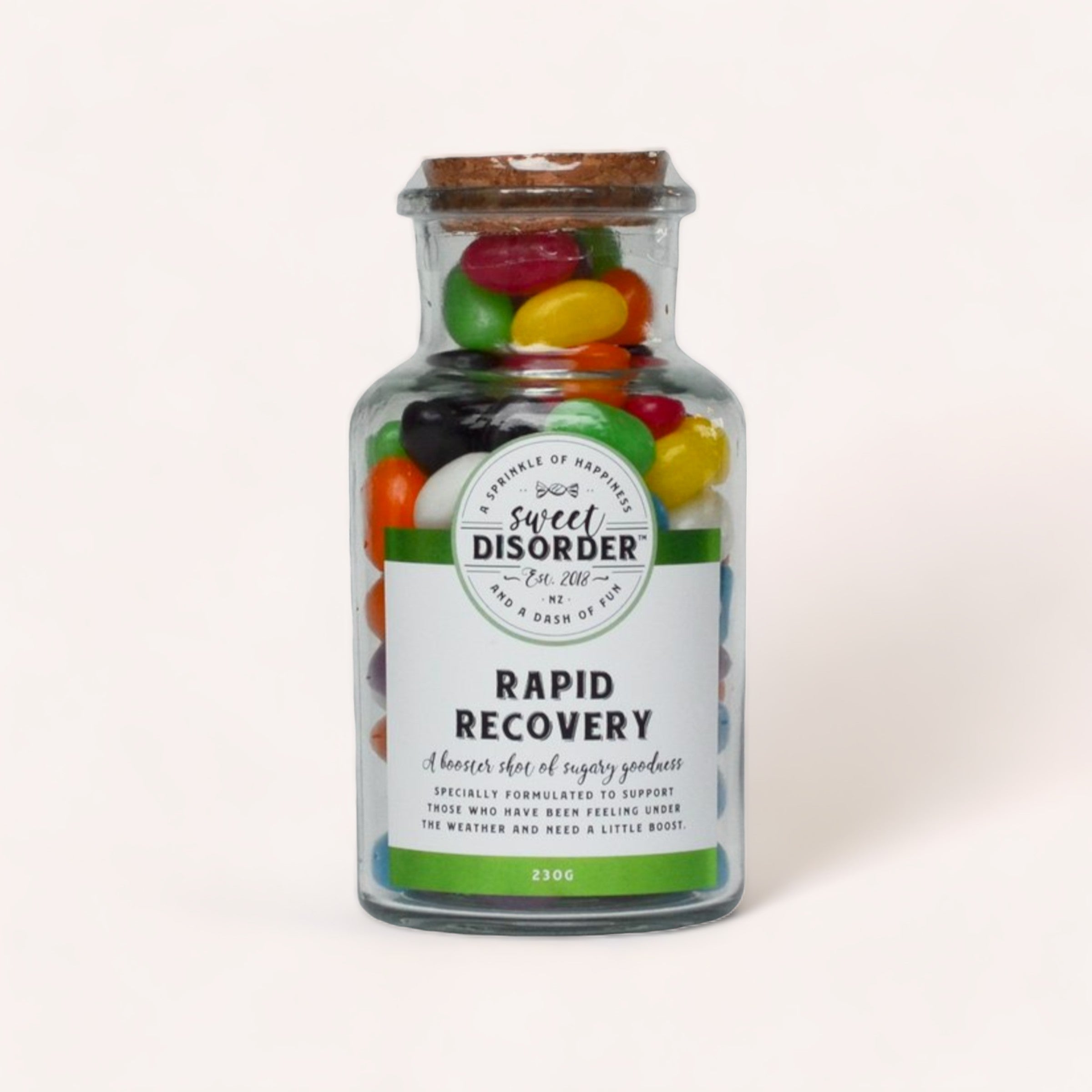 A bottle of assorted colorful jelly beans from New Zealand labeled "Rapid Recovery Lollies" by Sweet Disorder as a playful remedy for when you're feeling under the weather.