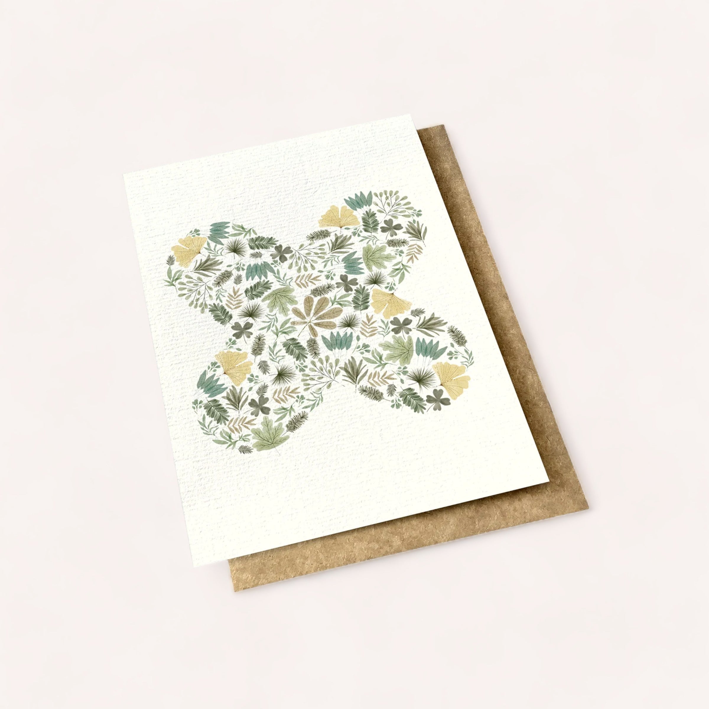 Floral Mandala Card with butterfly silhouette on a textured paper, accompanied by a kraft envelope on a plain background. Product of New Zealand. Made by Ink Bomb.