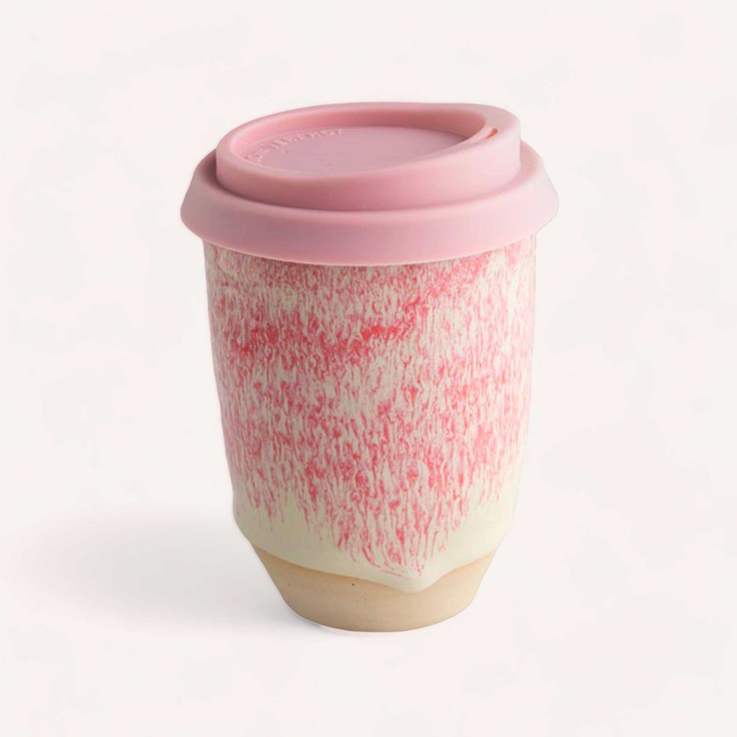 A handcrafted Ceramic Keep Cup by Sam Mayell, made from NZ sourced stoneware, featuring a unique pink textured design and a matching lid against a white background.