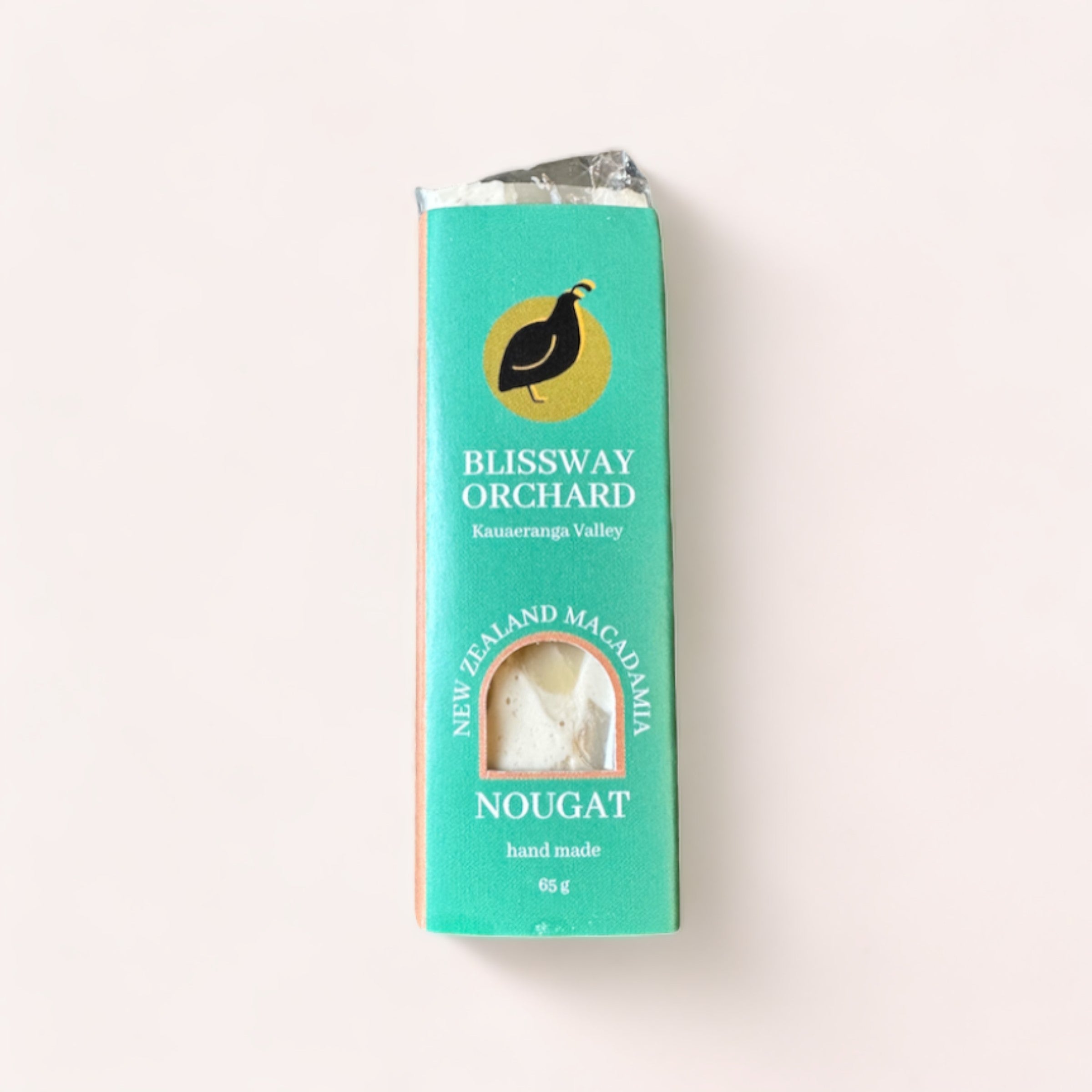 A wrapped bar of Macadamia Nougat by Blissway Orchard on a plain background.