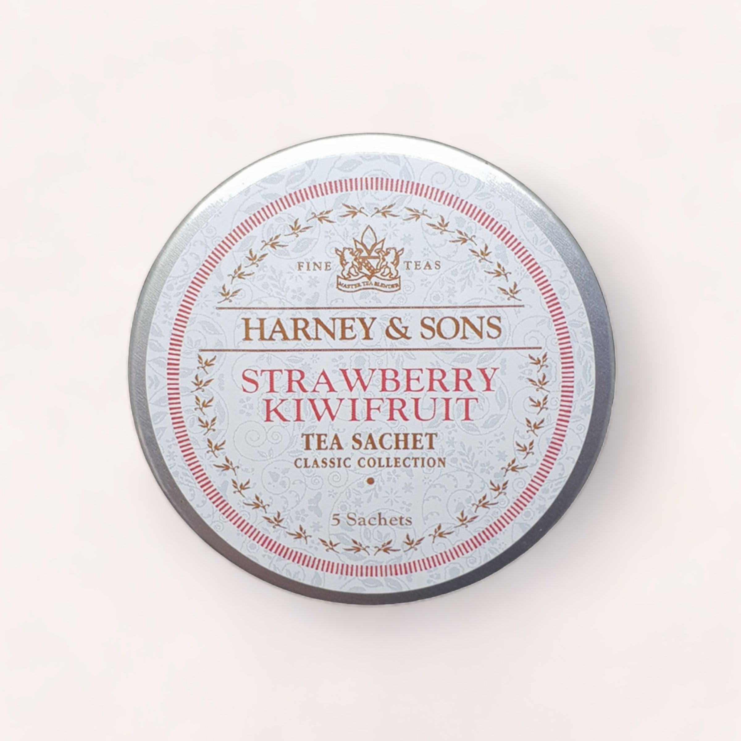 A round tin of Strawberry Kiwifruit Tea Tagalong by Harney & Sons, featuring strawberry kiwifruit flavor from their classic collection.