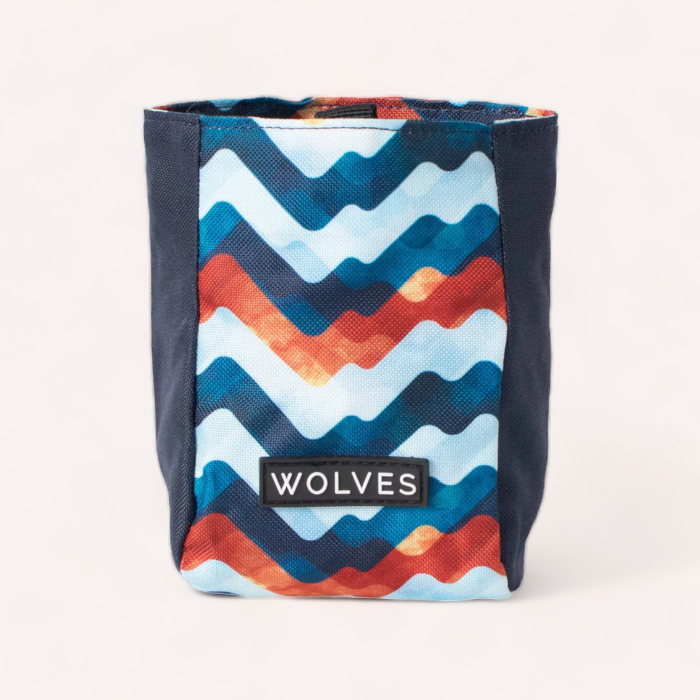 A durable, colorful Maverick Treat Pouch with a wavy blue, turquoise, and orange pattern on a white background, labeled 'Wolves of Wellington.