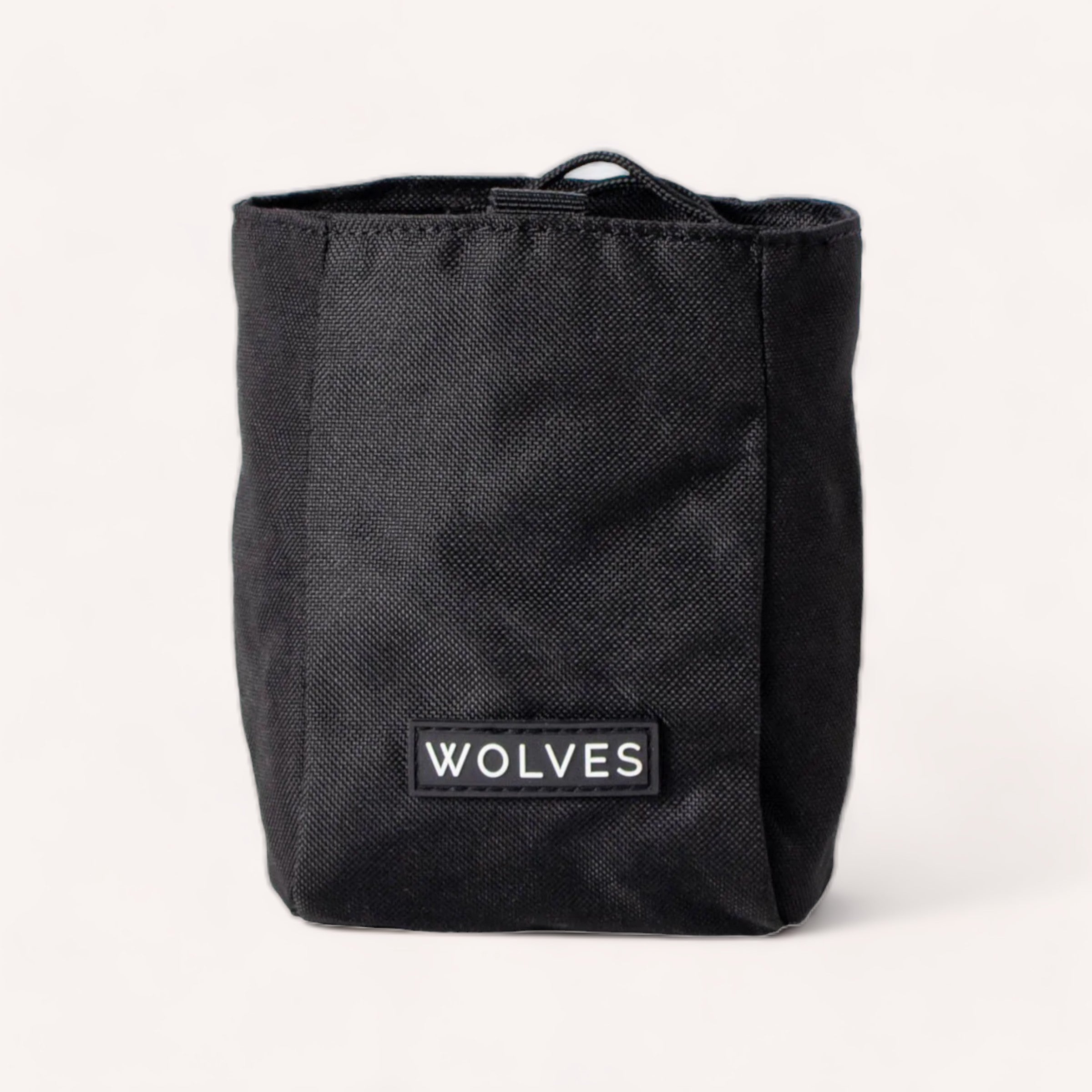 A Black Treat Pouch by Wolves of Wellington with the word "wolves" on a white label, useful for positive reinforcement training.