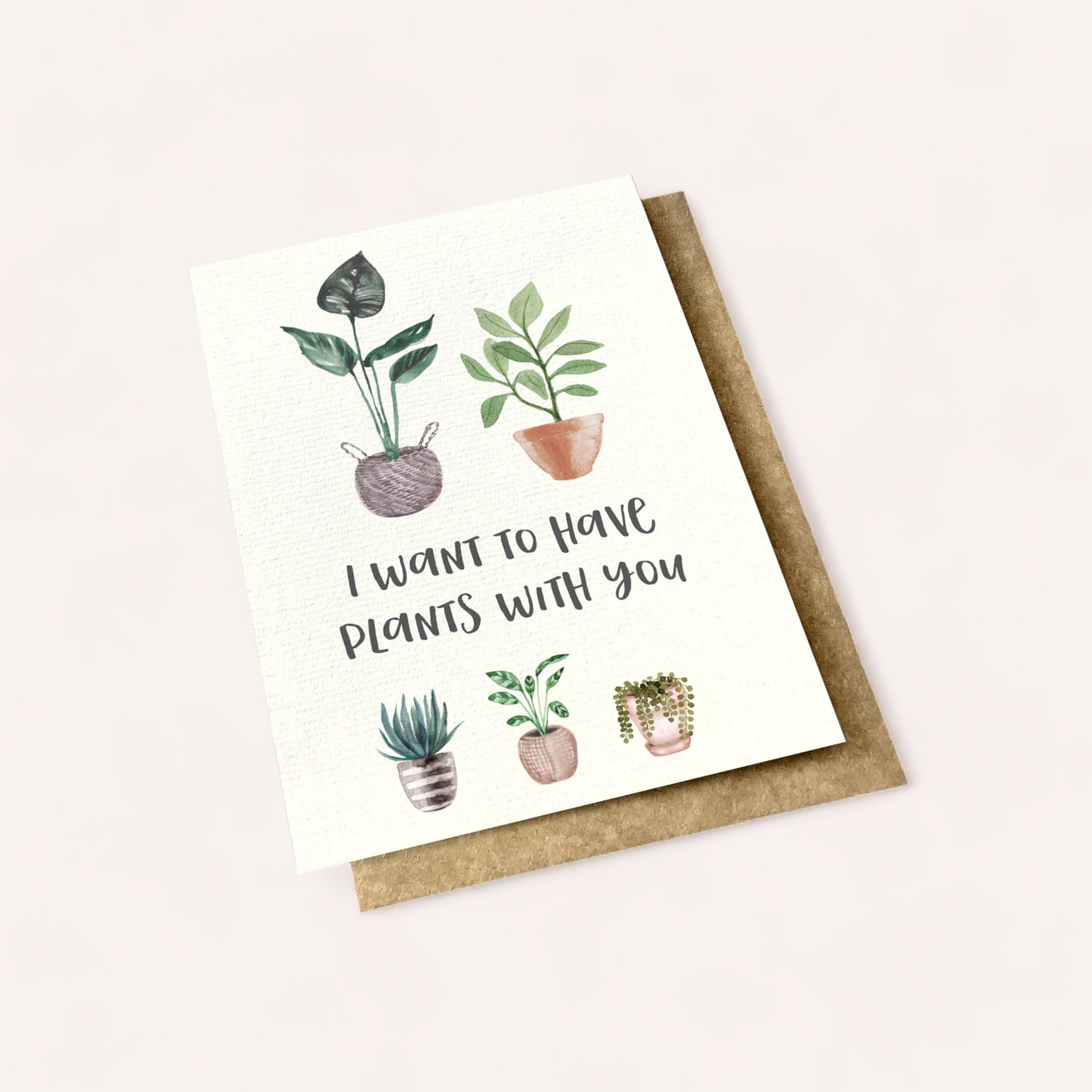A charming greeting card, a proud Product of New Zealand, features the punny phrase "i want to have plants with you" surrounded by watercolor illustrations of various potted plants, presented with an I want to have Plants With You Card by Ink Bomb.