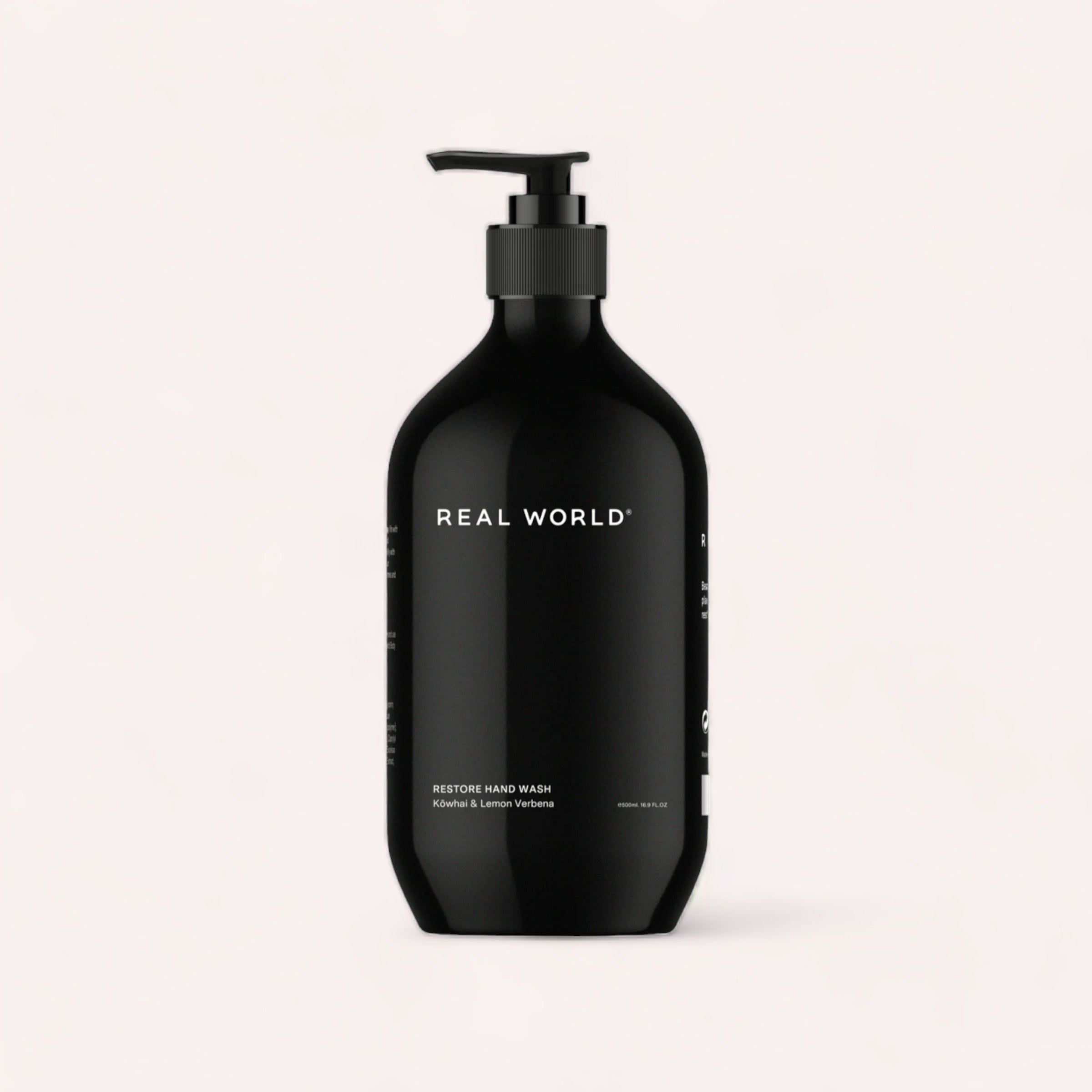 A sleek black bottle of Hand Wash - Kowhai & Lemon Verbena by Real World with a pump dispenser, labeled "Hand Wash - Kowhai & Lemon Verbena by Real World" against a clean, white background.