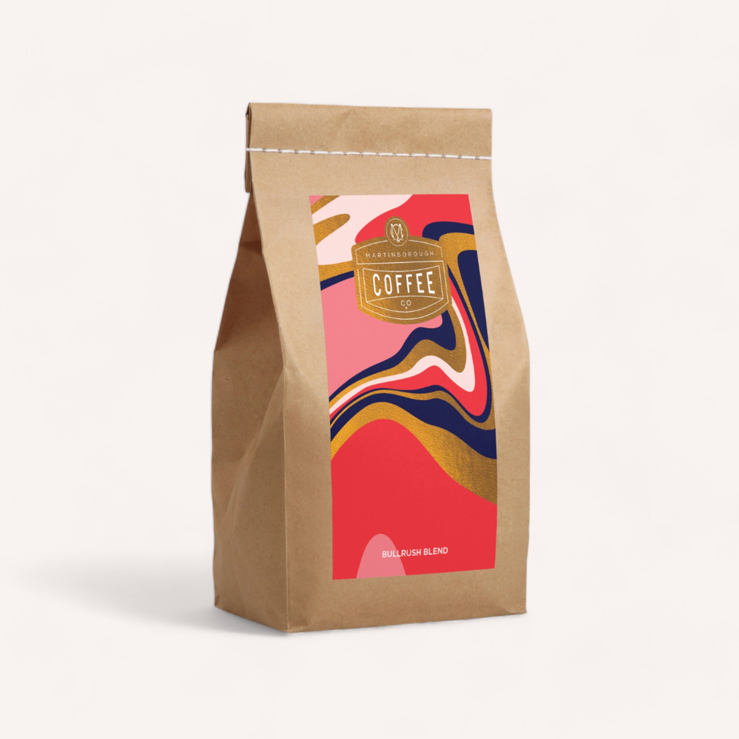 A stylishly branded Bullrush Coffee by Martinborough Coffee Co bag with a modern, colorful design, standing upright against a clean, white background.