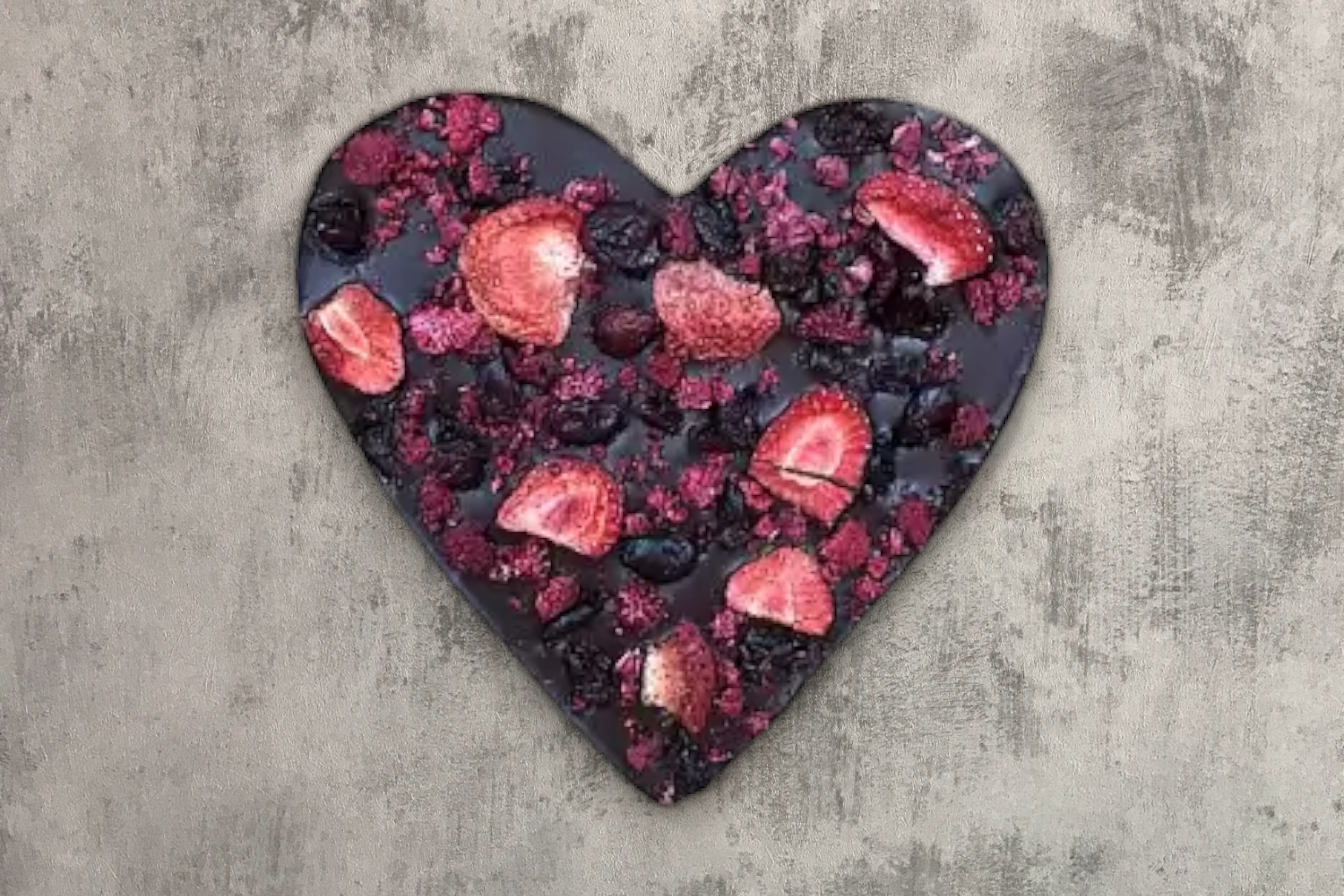 Heart-shaped arrangement of Mindful Moments berries on a rustic grey background, perfect as a self-care gift box addition from giftbox co.