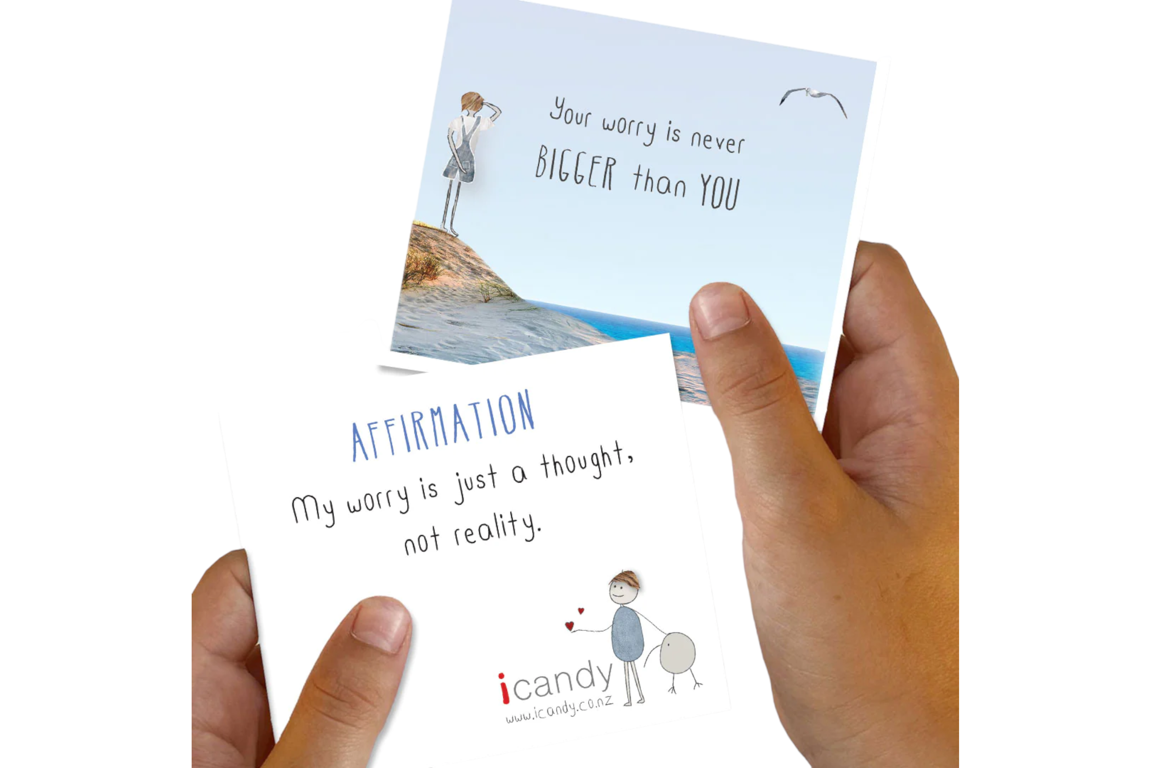 A person's hand holding two affirmation cards from the icandy Everyday Inspiration - Positivity Pack with encouraging inspiration messages about managing worry, one with a seaside background and another with a simple illustration of a person.