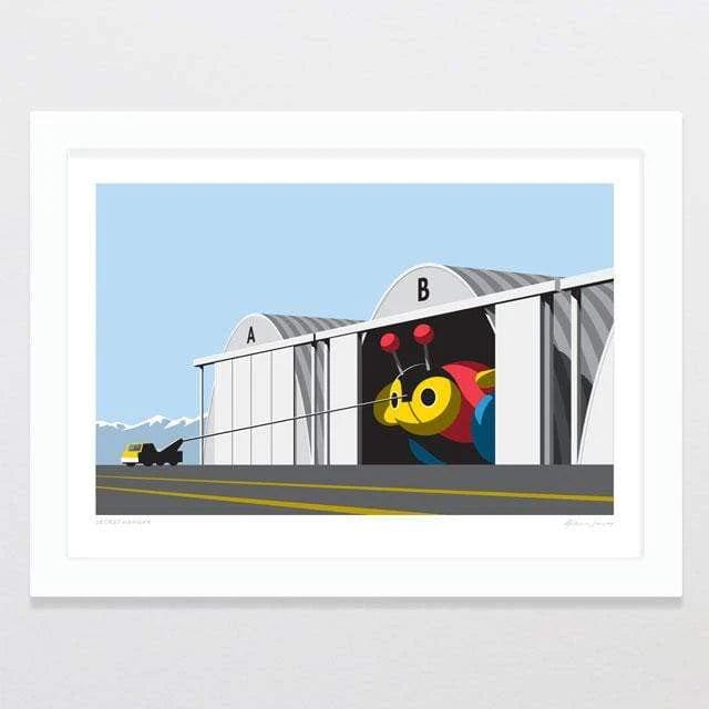 Modern art meets industrial setting: a vibrant, abstract painting of a bird by Glenn Jones playfully interrupts the stark, geometric lines of a warehouse facade.