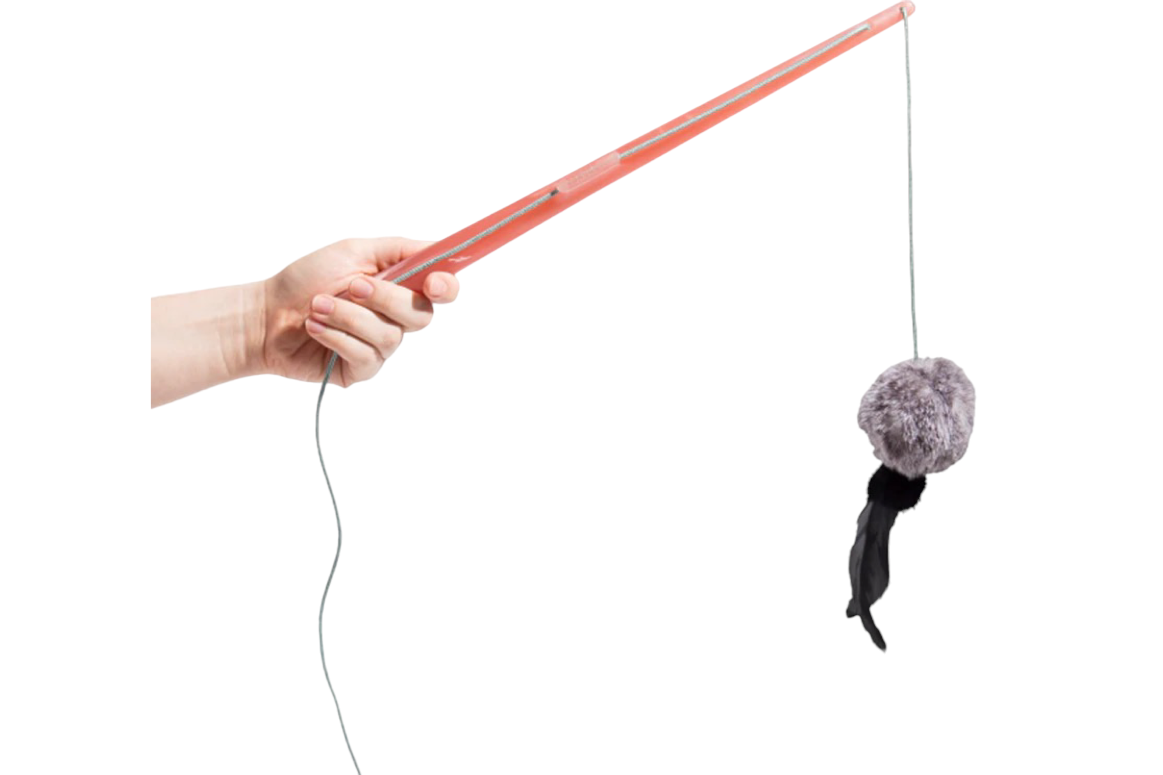 A person's hand holding a Zee.Cat Wand Toy with a plush ball, feathers, and bells dangling on a string, isolated on a white background.