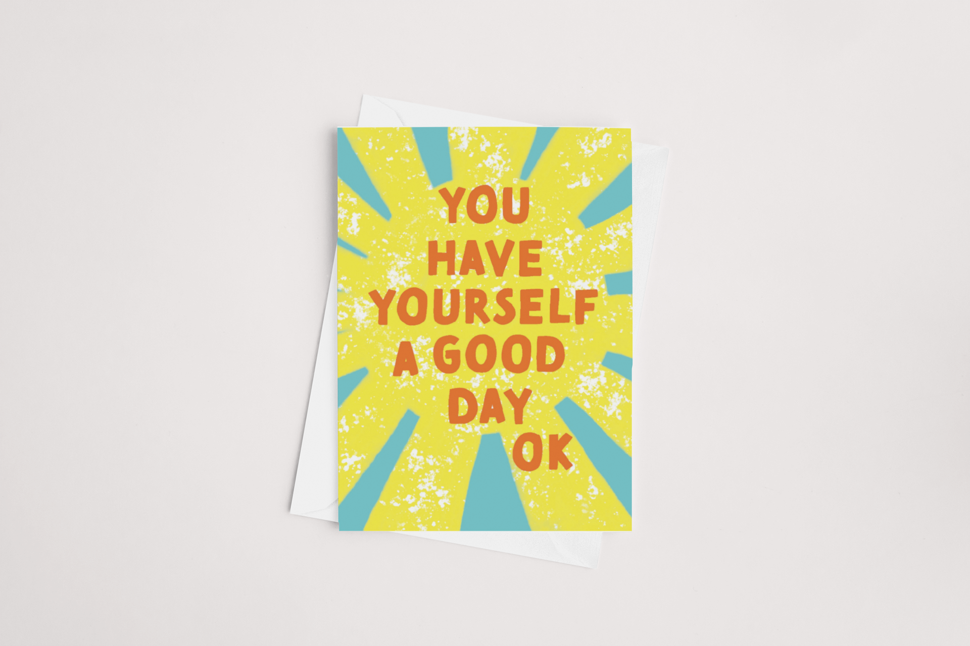 Vibrant Good Day Card, a product of Tuesday Print from New Zealand, with an encouraging message, "you have yourself a good day ok," set against a dynamic yellow and blue starburst pattern.