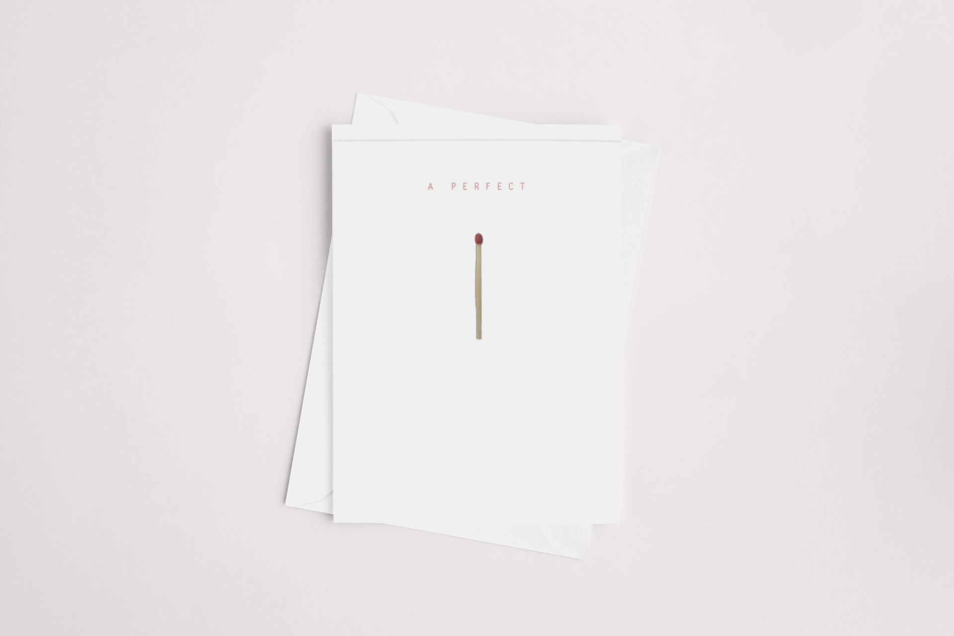 A minimalistic design featuring two white sheets of paper, the top one with a single red matchstick printed in the center and the phrase 'a perfect' printed above it. This Perfect Match Card is a icandy.