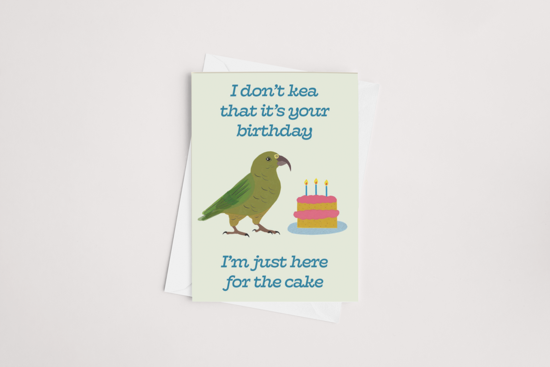 A Kea Birthday Card featuring an illustration of a parrot next to a cake with the humorous caption, "I don't 'kea that it's your birthday. I'm just here for the cake," by Tuesday Print.