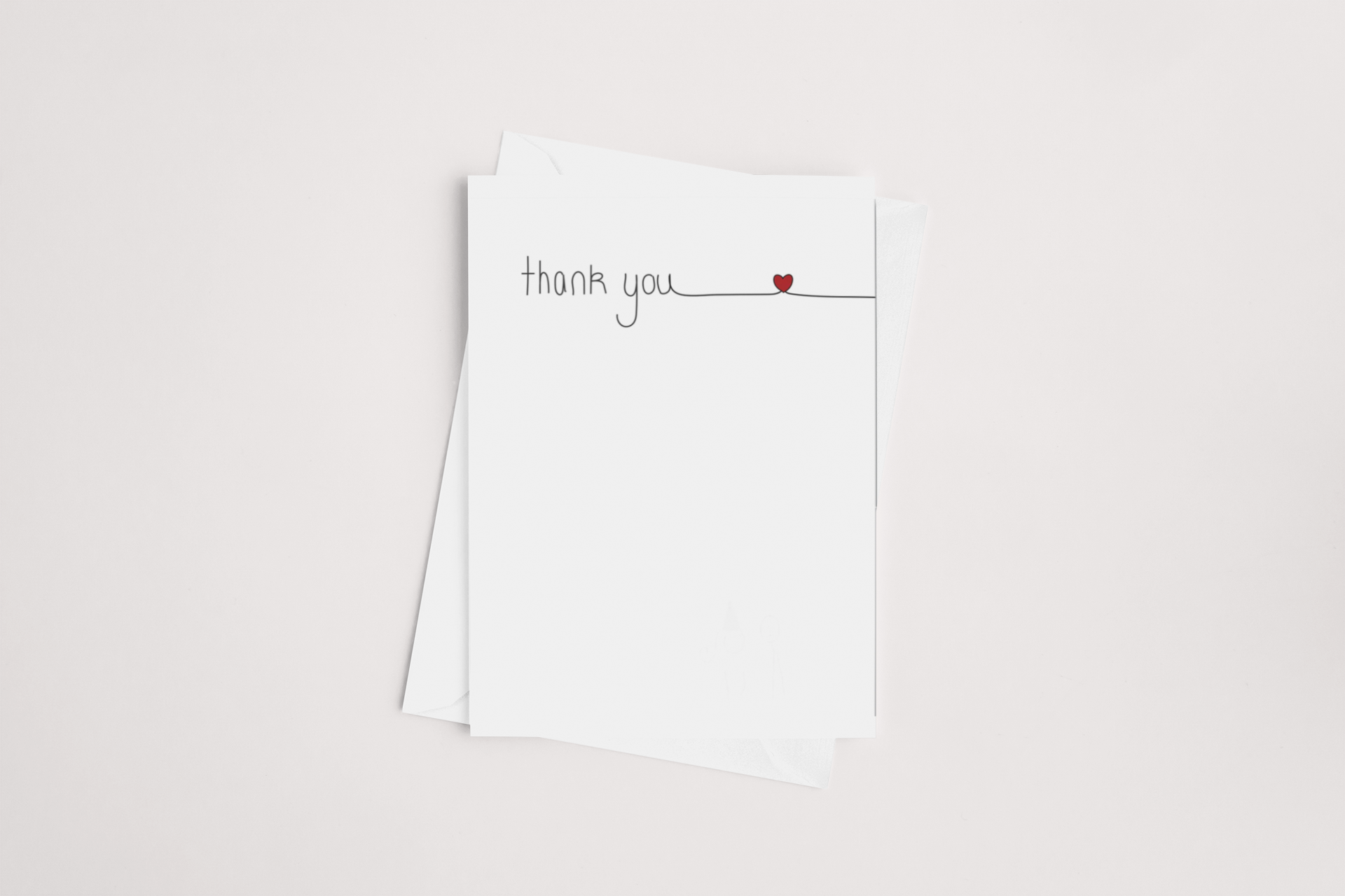 A simple yet elegant icandy "thank you" greeting card with a small red heart detail, placed on top of a white envelope against a clean background.