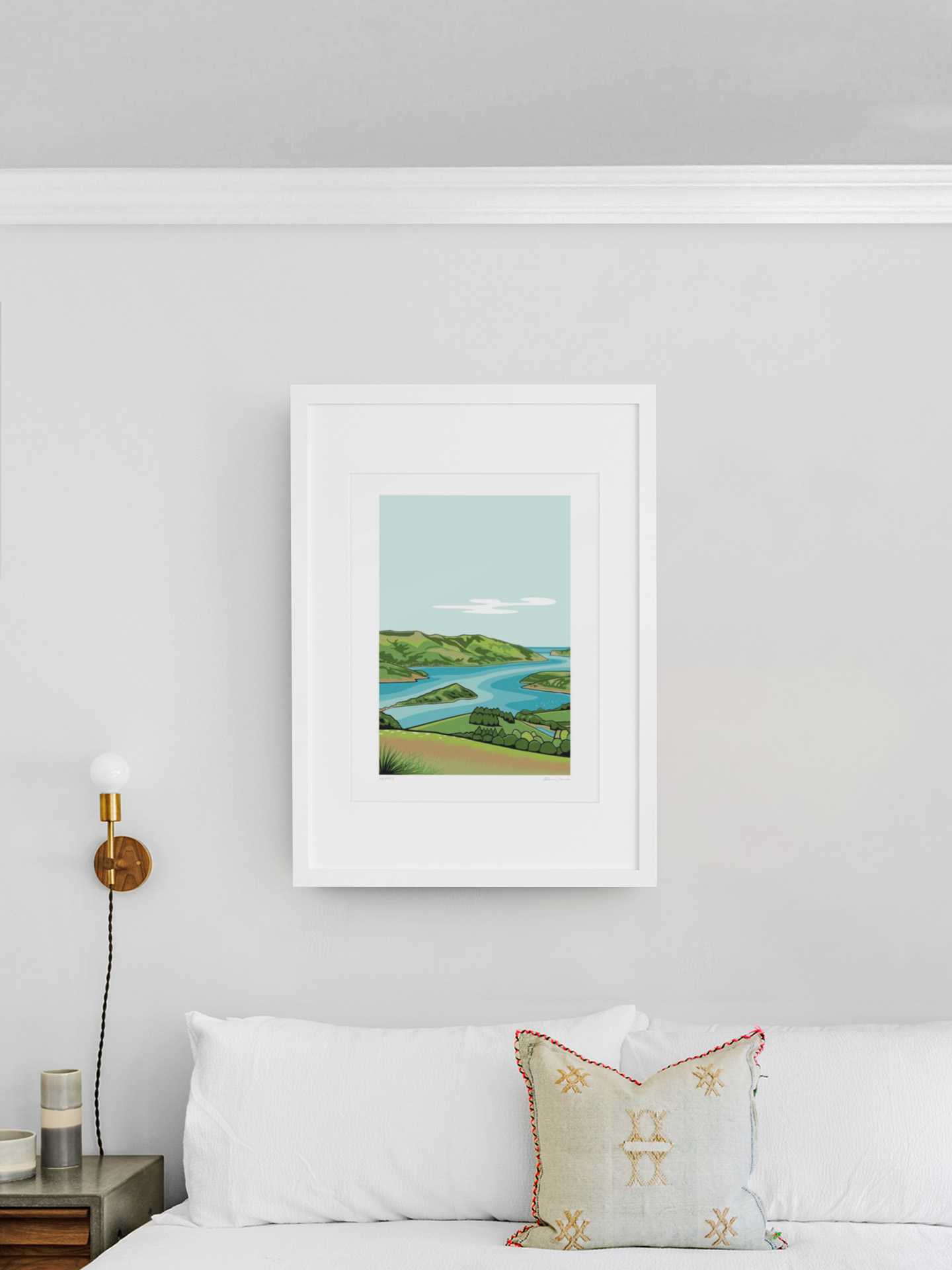A serene Akaroa by Glenn Jones landscape painting framed elegantly on a clean white wall, adding a touch of tranquil nature to a modern and cozy living space.