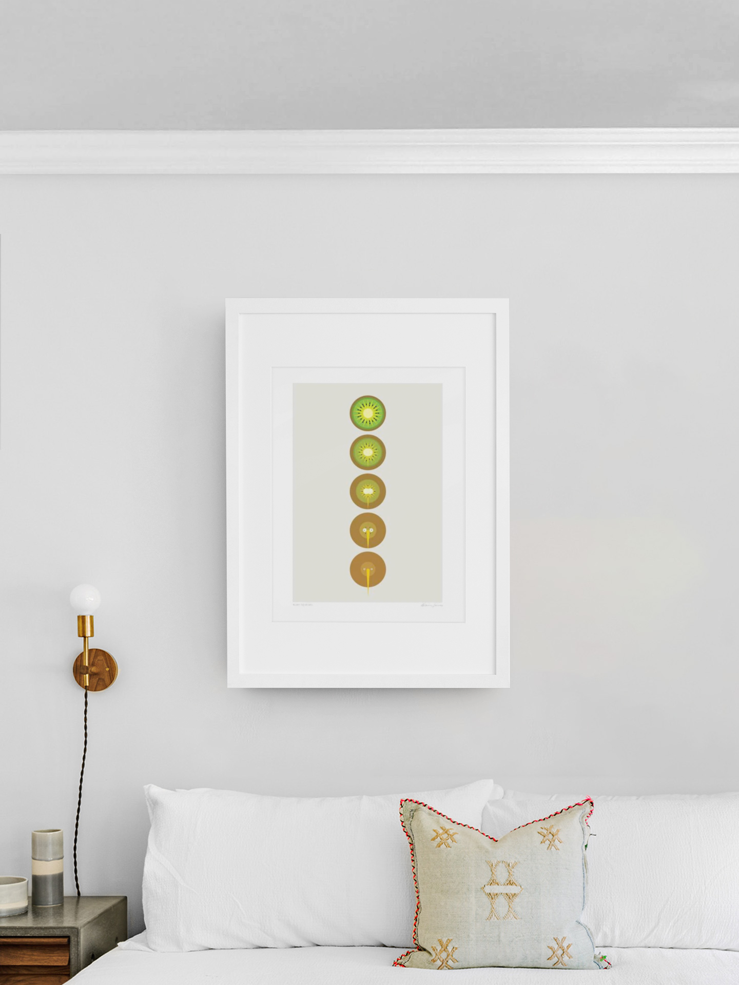 A serene living space featuring a neatly organized vertical arrangement of seven Kiwi to Kiwi slices in a frame, adding a vibrant yet simplistic touch to the minimalist decor by Glenn Jones.