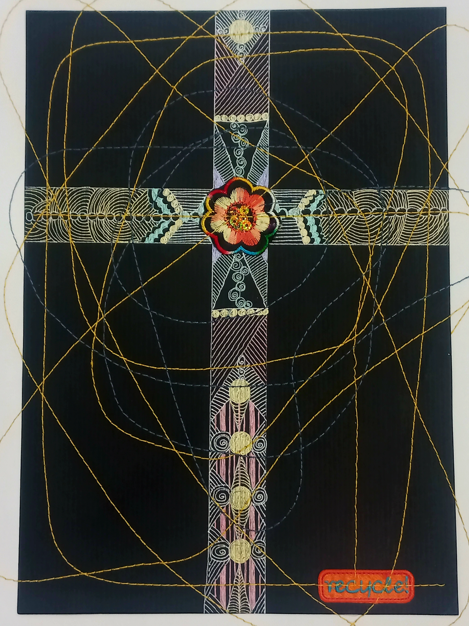 An artistic representation of a cross with intricate patterns and a flower at the center, set against a dark background with abstract golden lines. This original artwork is rendered as Recycle, a pen and ink drawing inspired by Louise Keen.